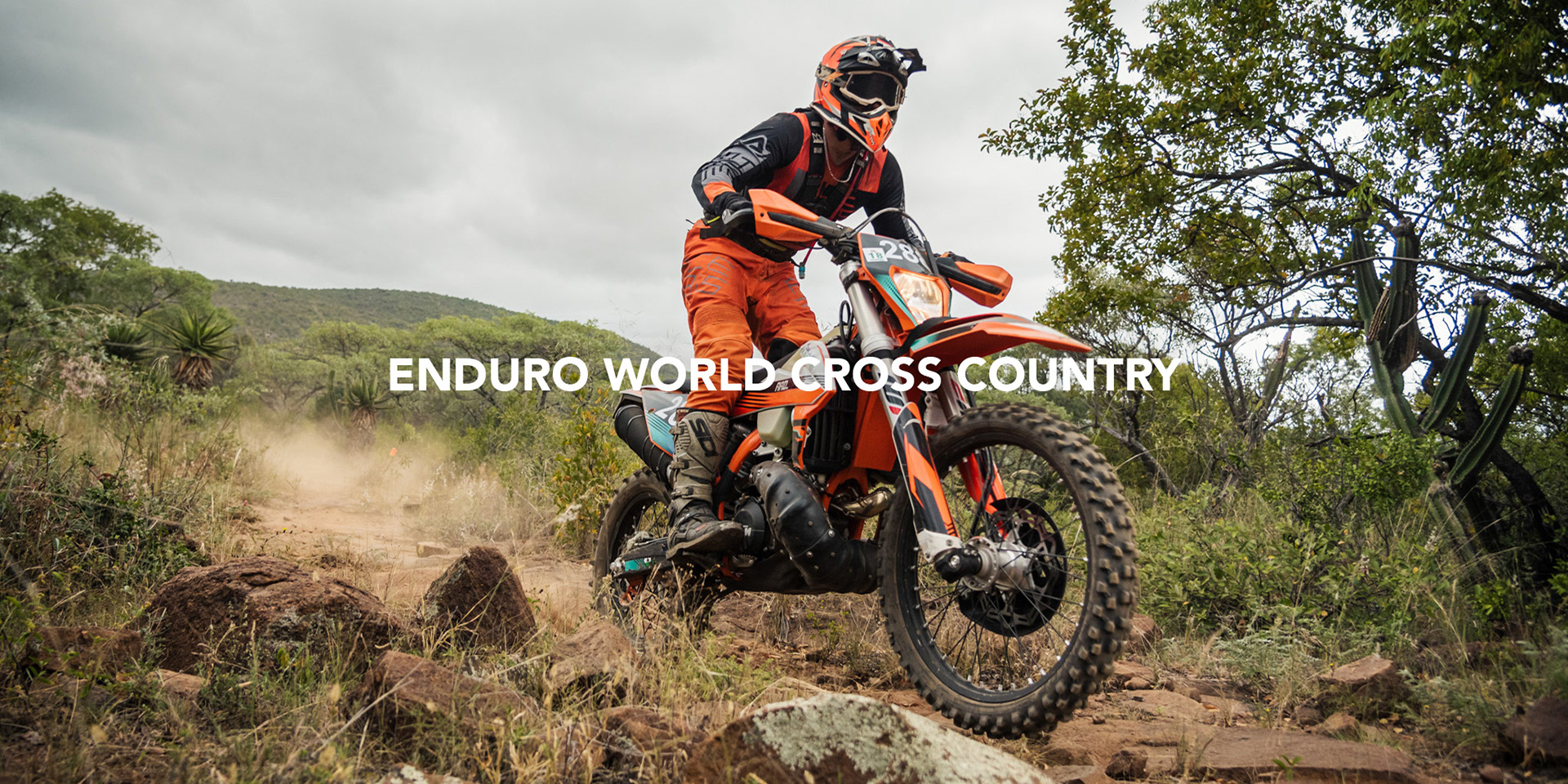 dynamic image of a motorcycle cross country racer speeding across the bushveld during a race photographed by black rock studio