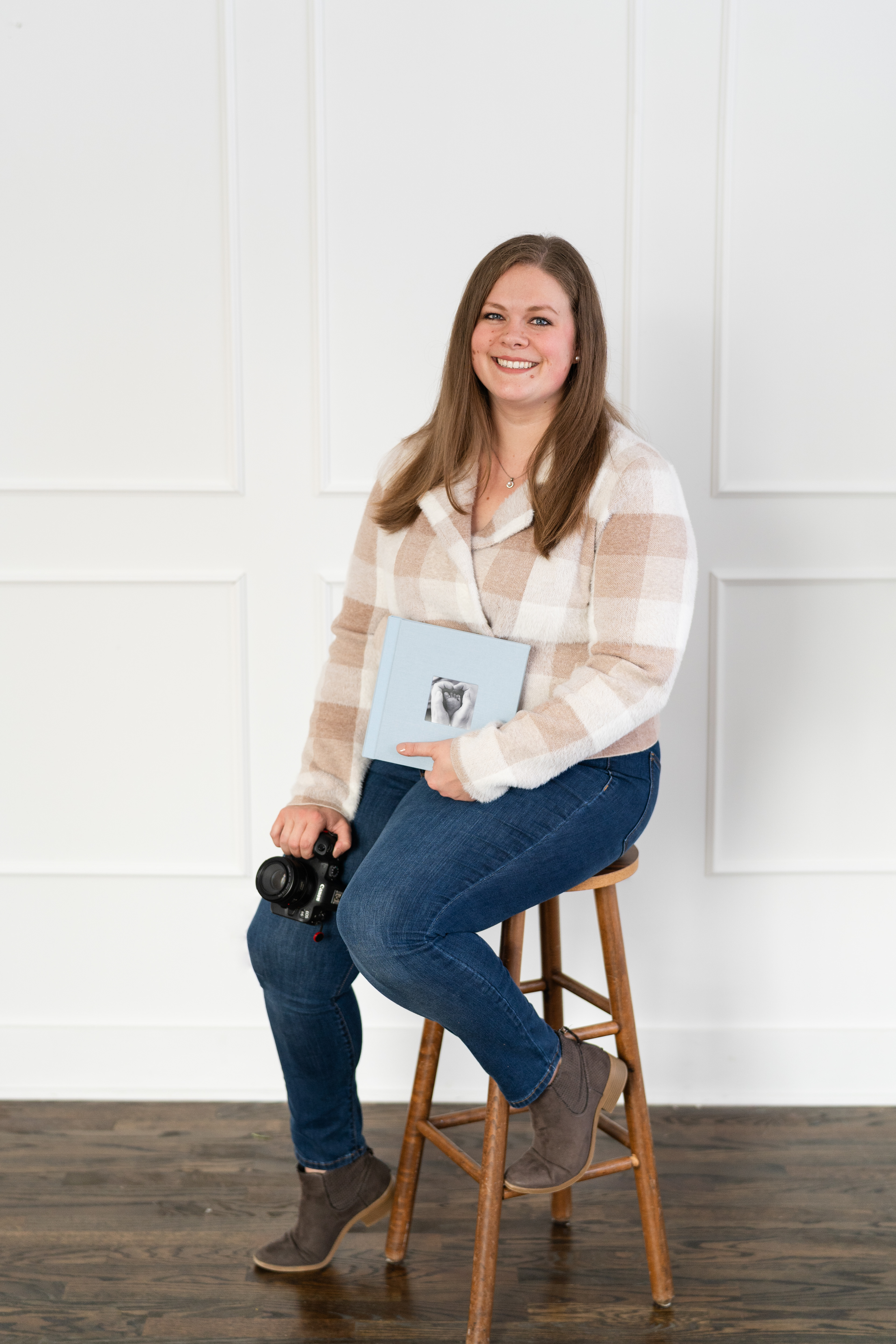 Ashley with an 8x8 Lifestyle Newborn Album and Canon Camera
