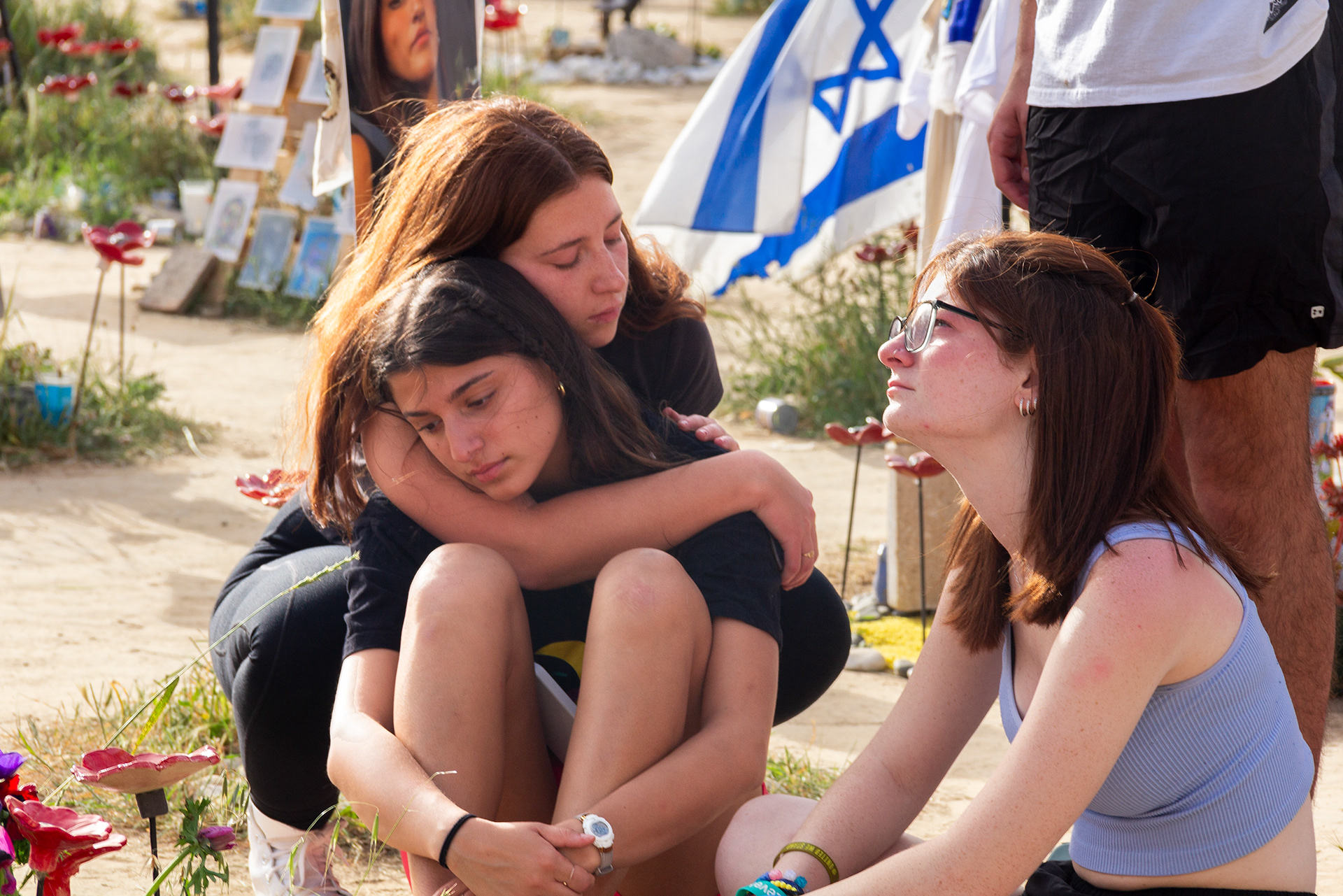 At the Nova festival site near Re’im, young people gather and mourn the loss of their loved ones on October 7, 2023.