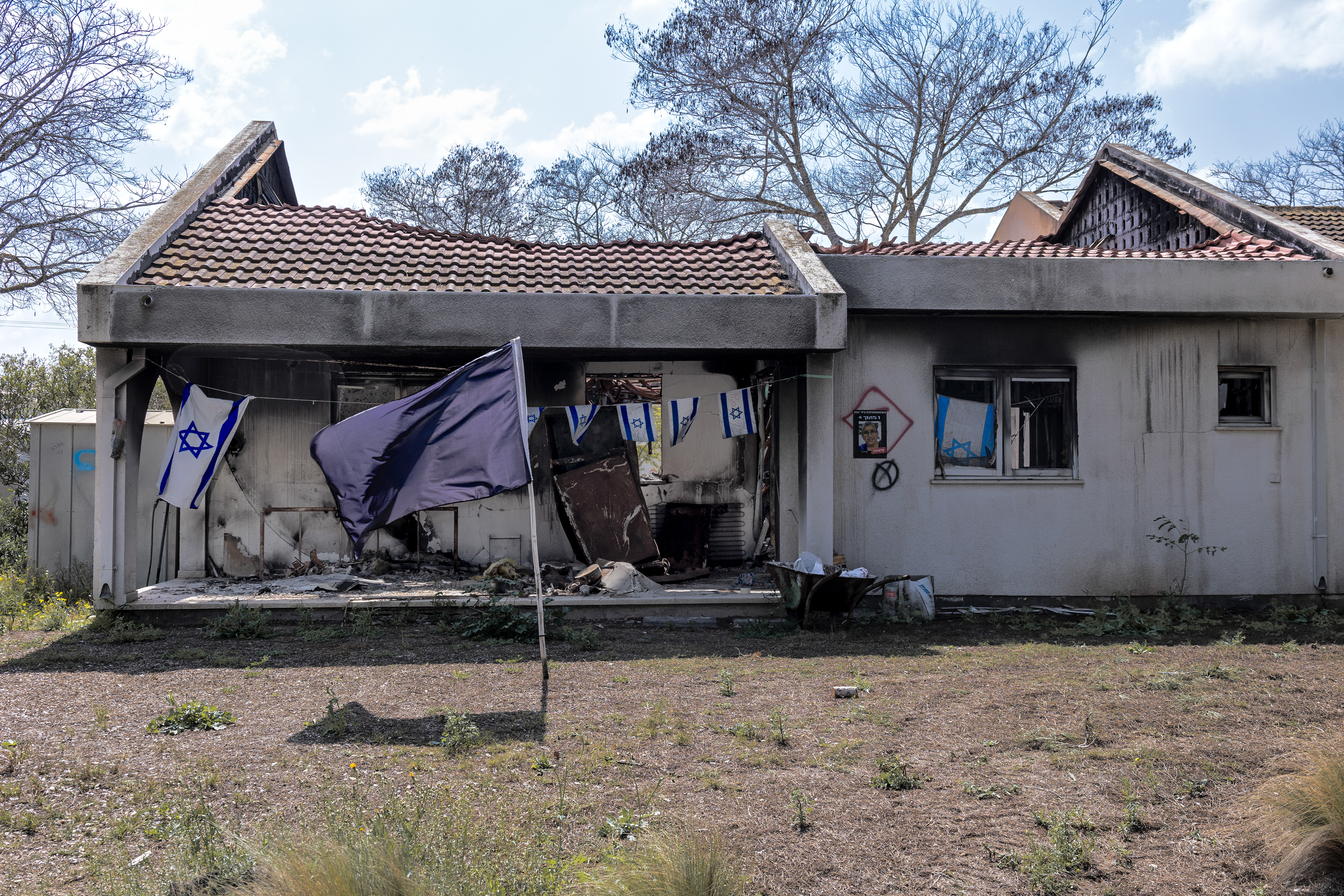 The charred remains of a house in Nir Oz, where a family was killed on October 7, 2023, in Israel.