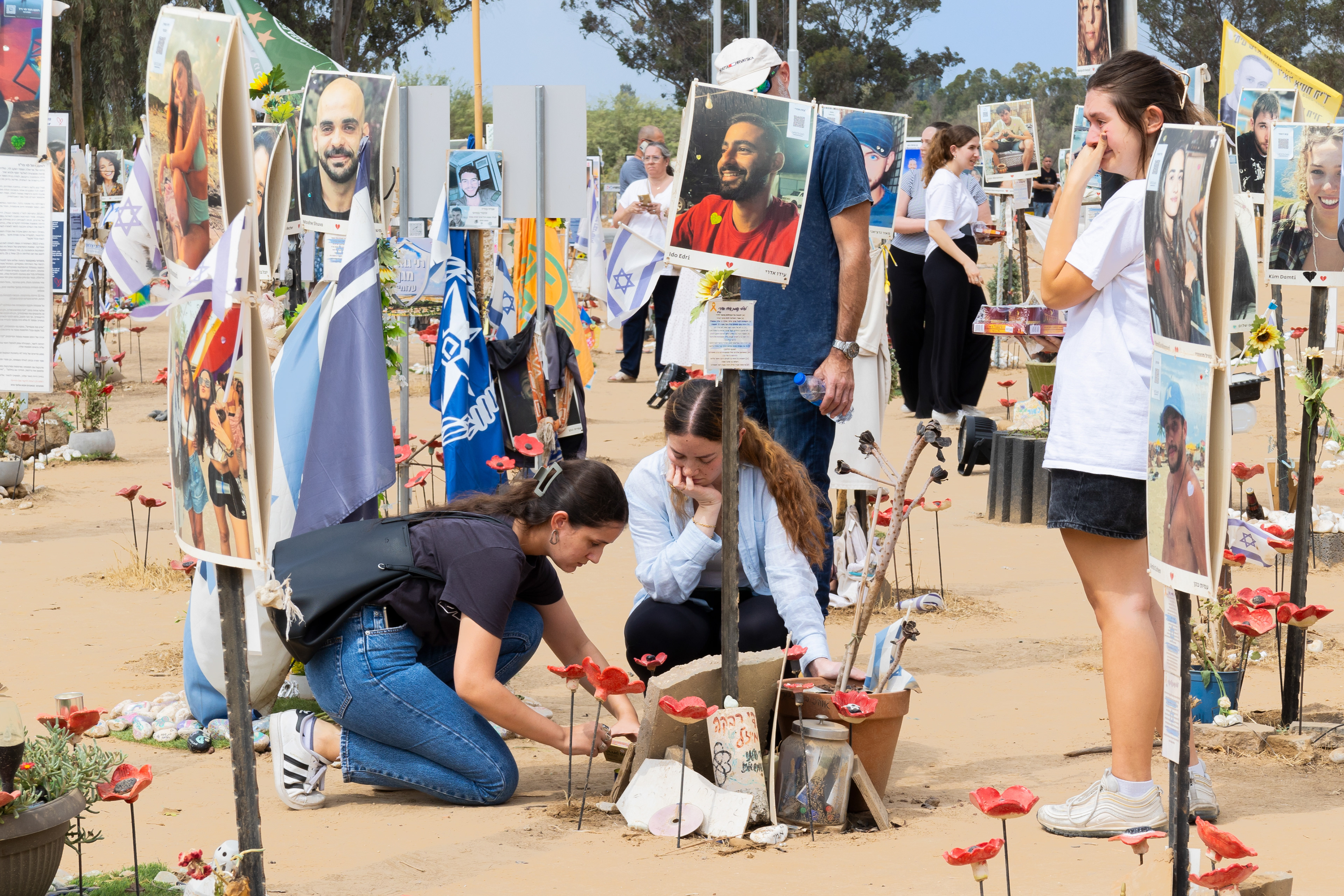 Young girls light candles and mourn the death of Ido Edri, who was killed at the Nova festival on October 7, 2023.