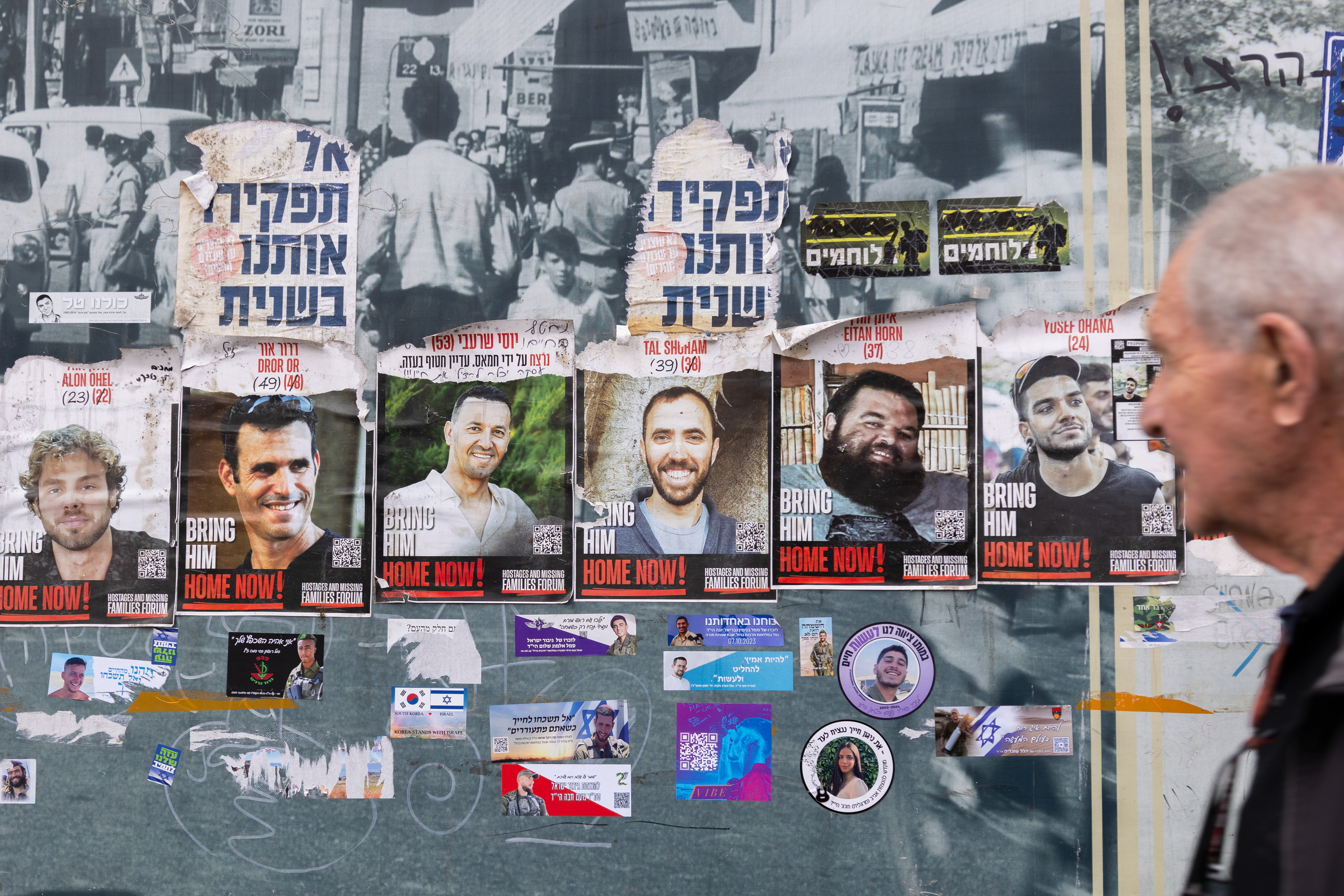 Posters of hostages and fallen soldiers displayed on walls in Jerusalem.