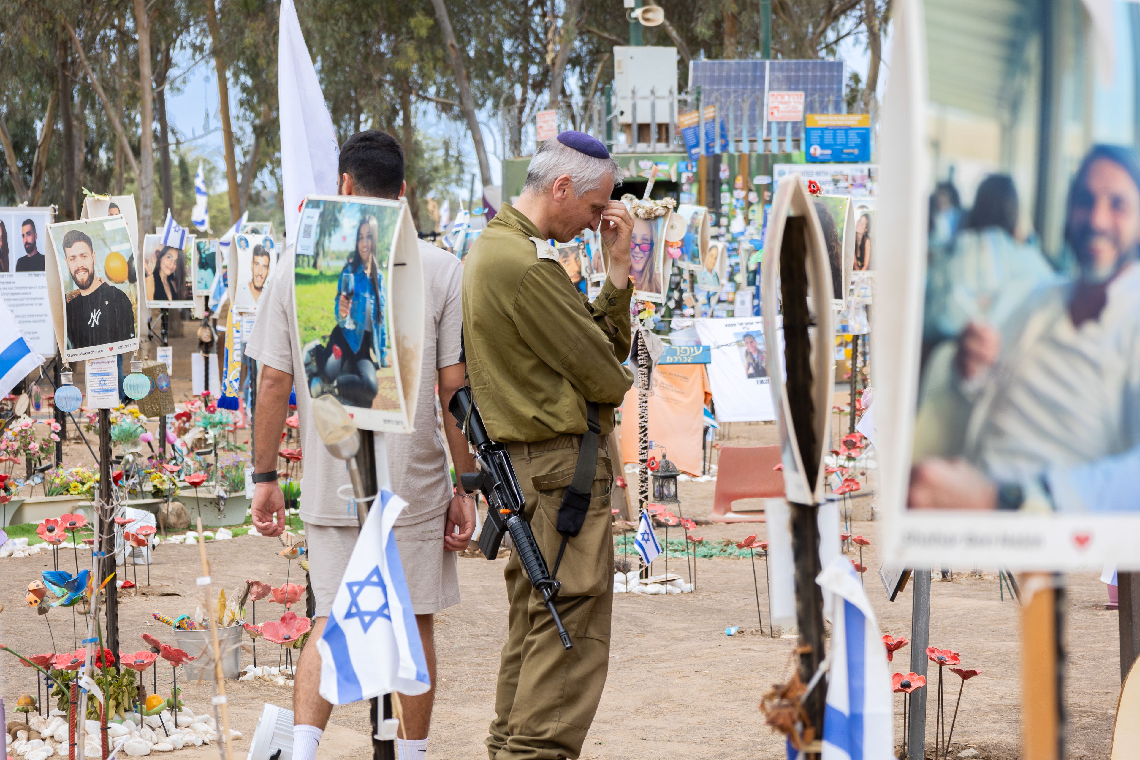 A soldier pays his respects at the Nova festival site, in Israel,  where many young people lost their lives.