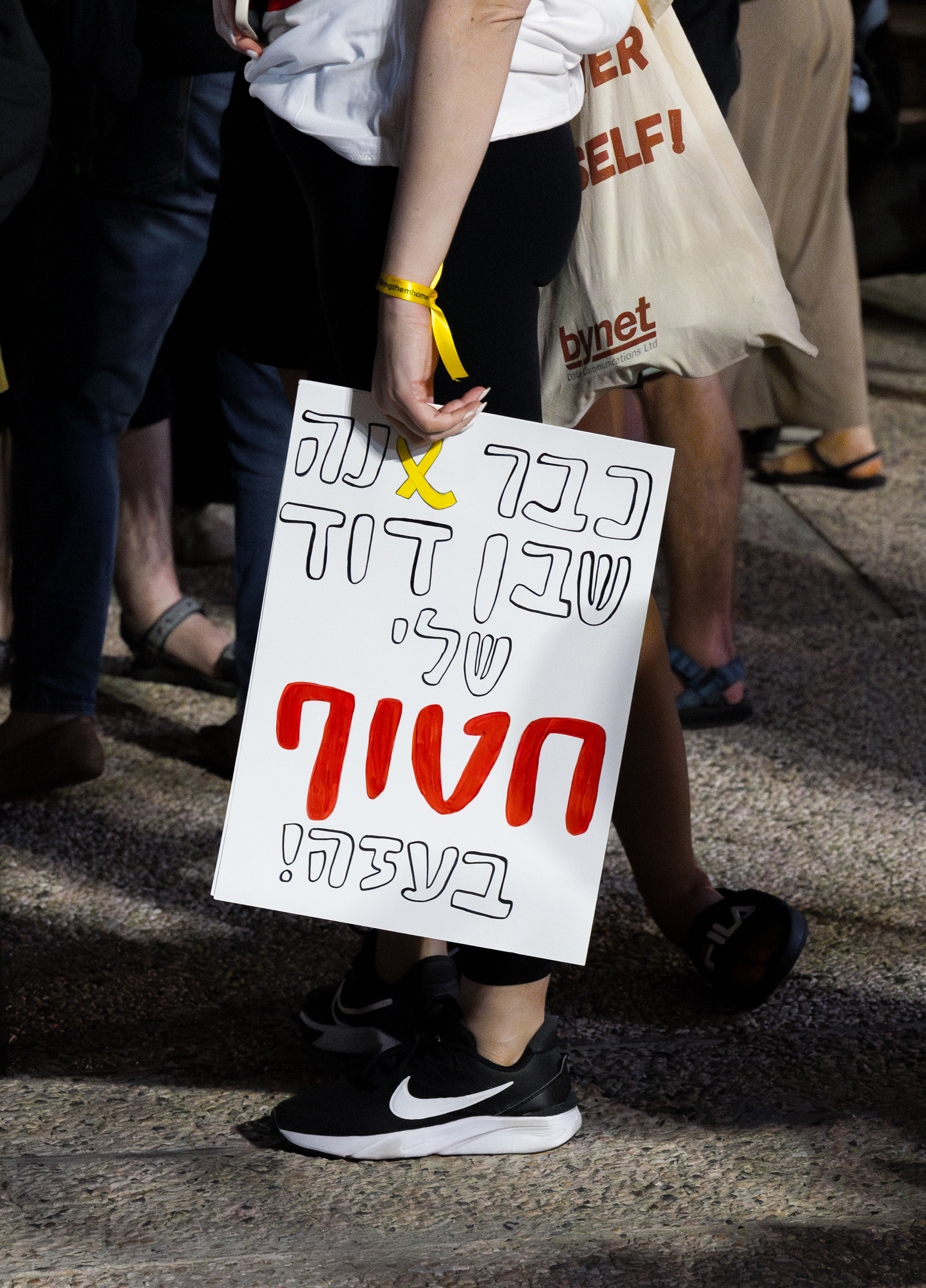 In Tel Aviv, a protester holds a sign reading, ‘It’s already been a year since my cousin was taken hostage in Gaza,’ during a demonstration calling for the return of the hostages.