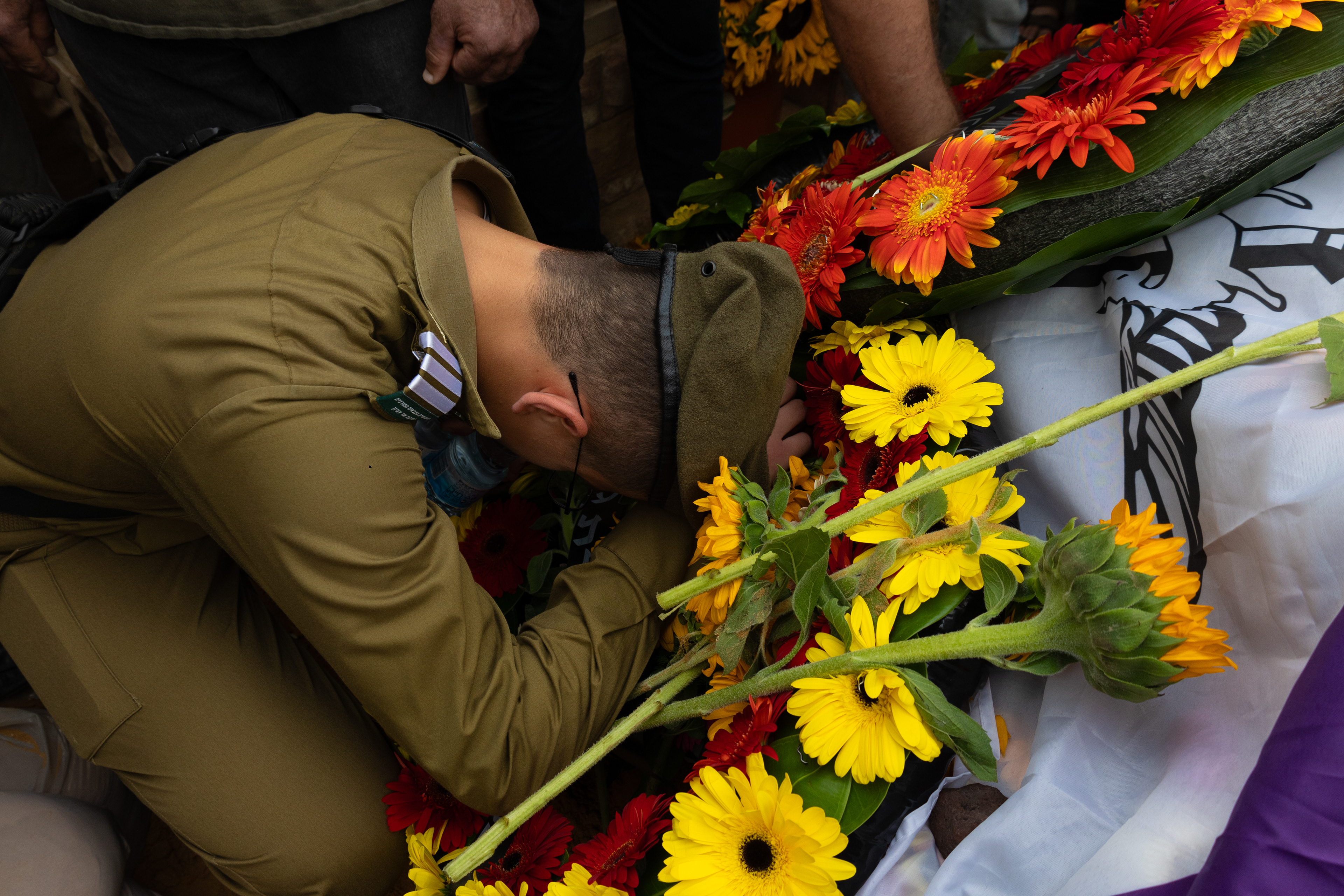 A soldier weeps at the grave of fallen soldier and former hostage Hadar Goldin during his burial, more than 11 years after his death and captivity, on November 11, 2025, at the Kfar Saba military cemetery in Israel.