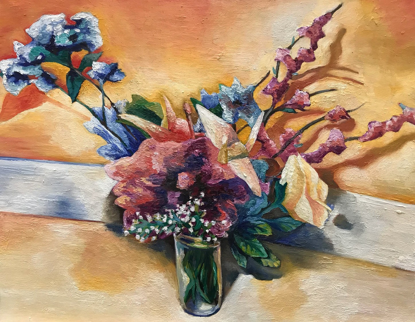 Shows a flower in a vase with paper cranes.