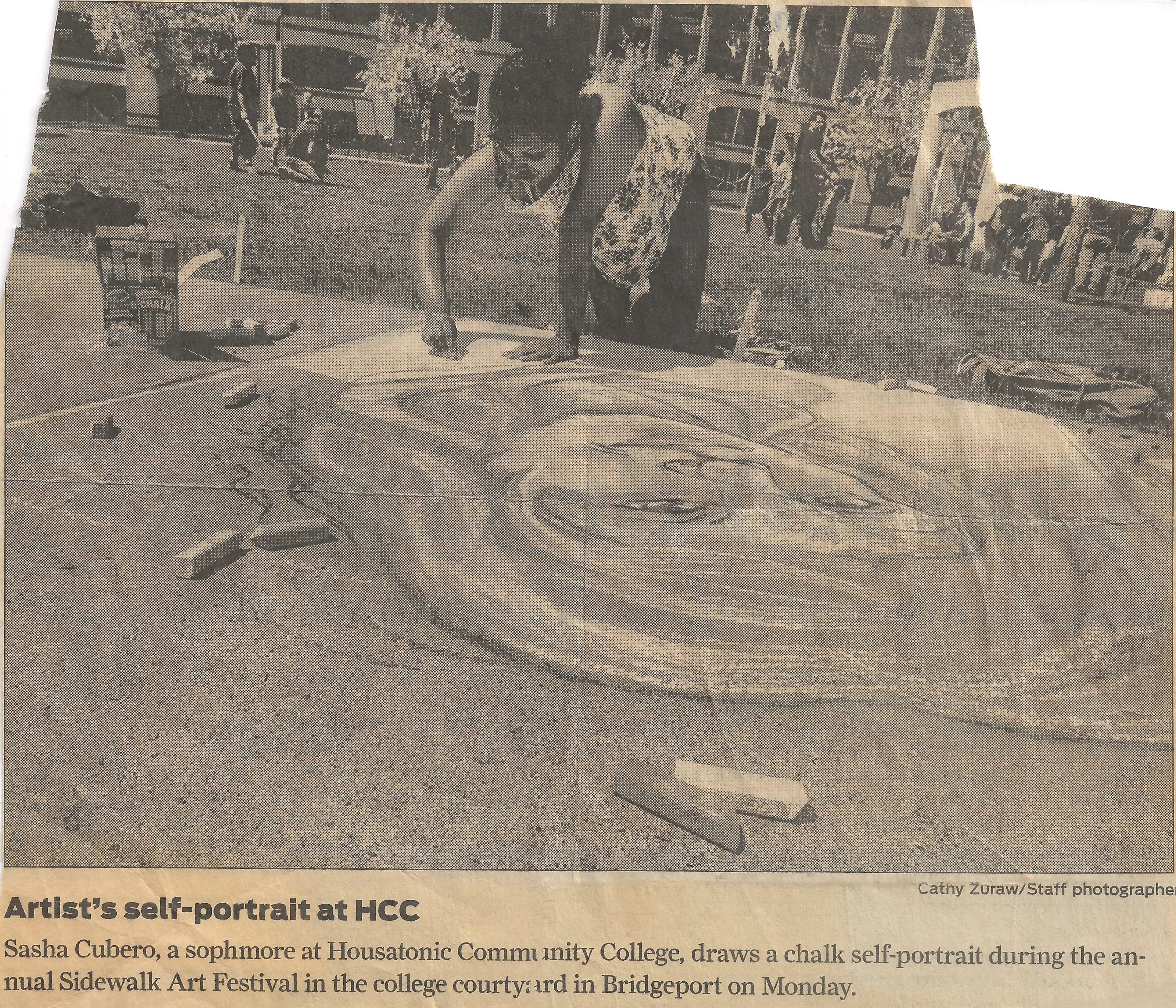 Newspaper clipping from the Connecticut Post about Sasha Cubero drawing a self-portrait chalk artwork on the ground during the Housatonic's Sidewalk Art Festival Contest