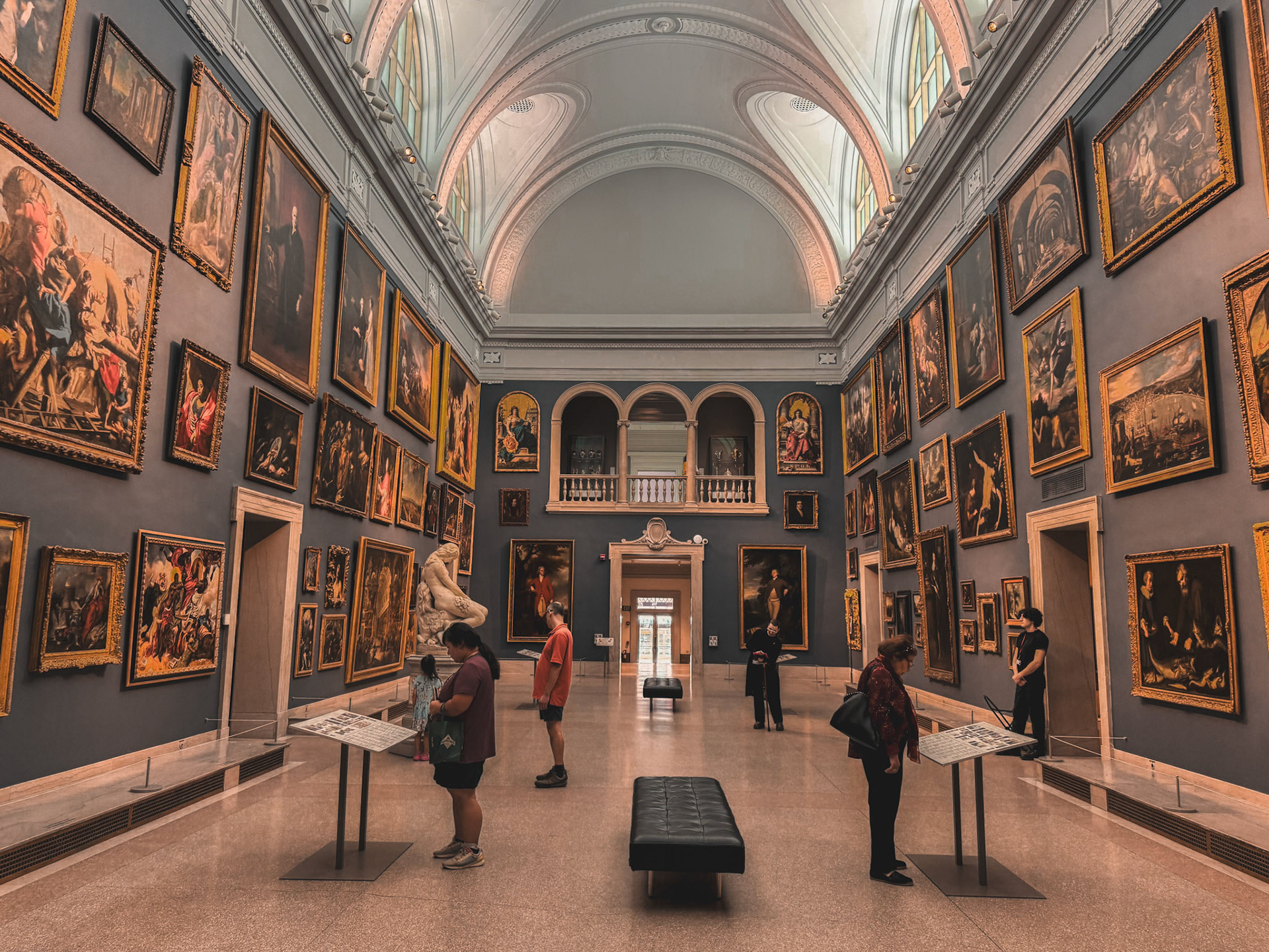 Picture of the Morgan Great Hall with paintings all over the walls.