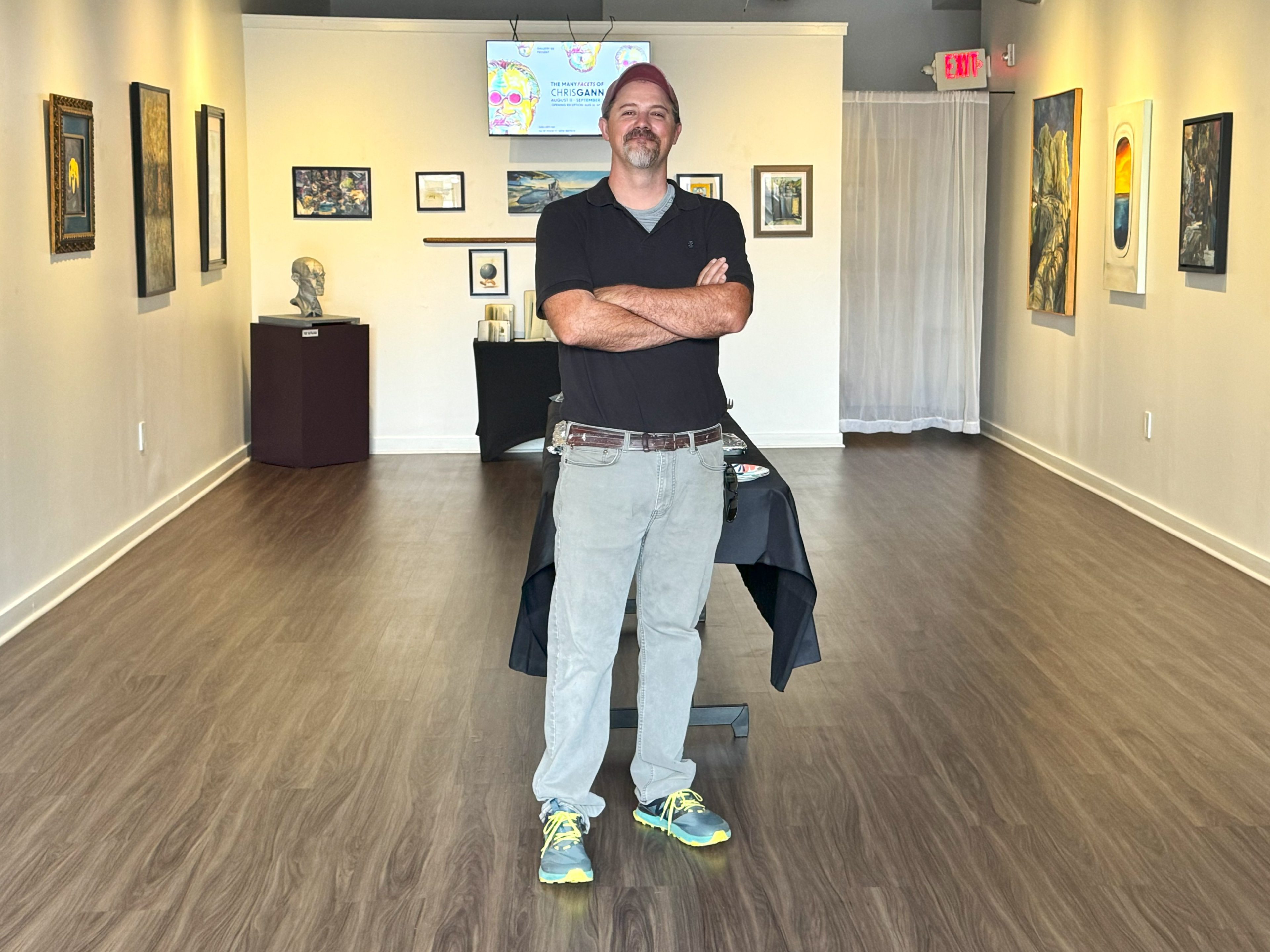 The artist of the exhibition, Chris Gann, is posing for a picture.