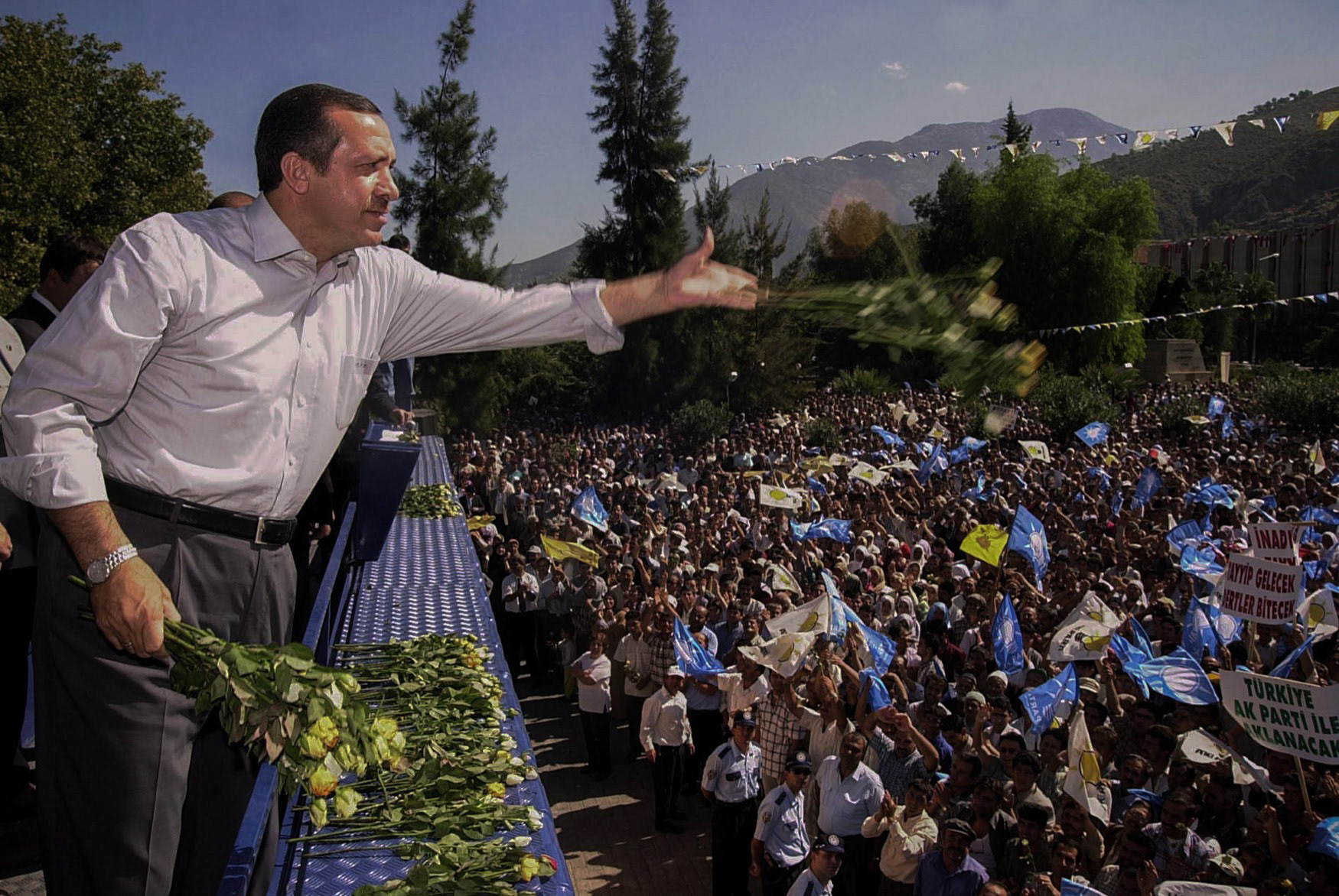 Justice and Development Party leader Recep Tayyip Erdoğan gives flowers to his supporters at Fethiye, Muğla, 2002