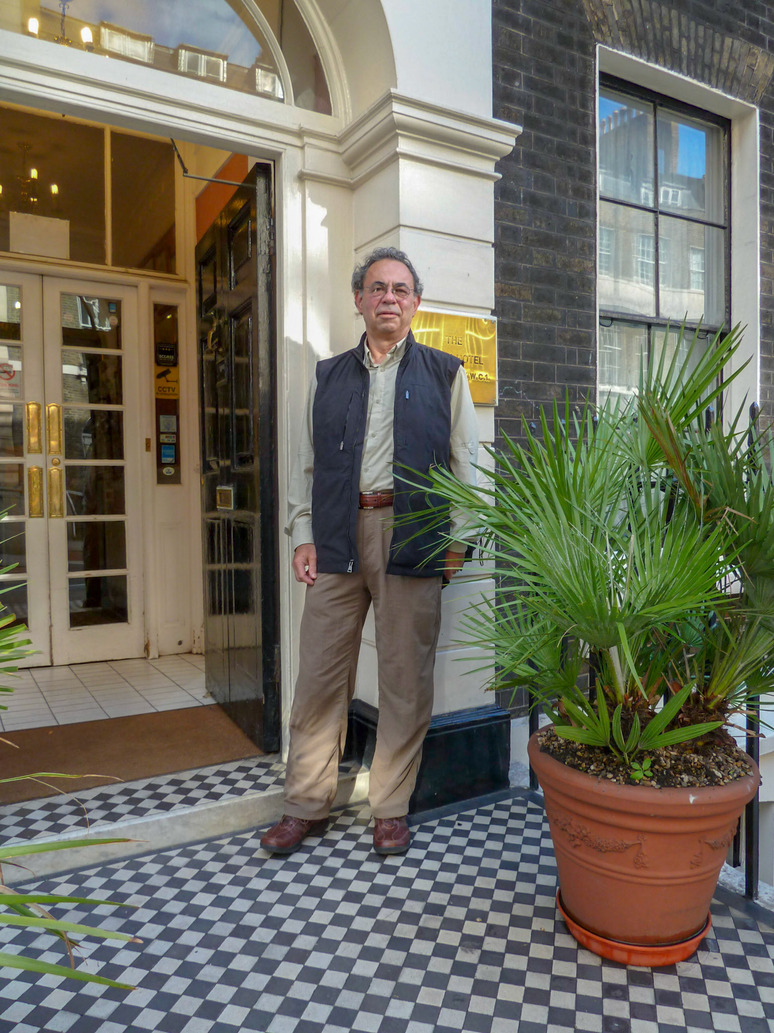 Dennis lingers at the door of the Garth Hotel.