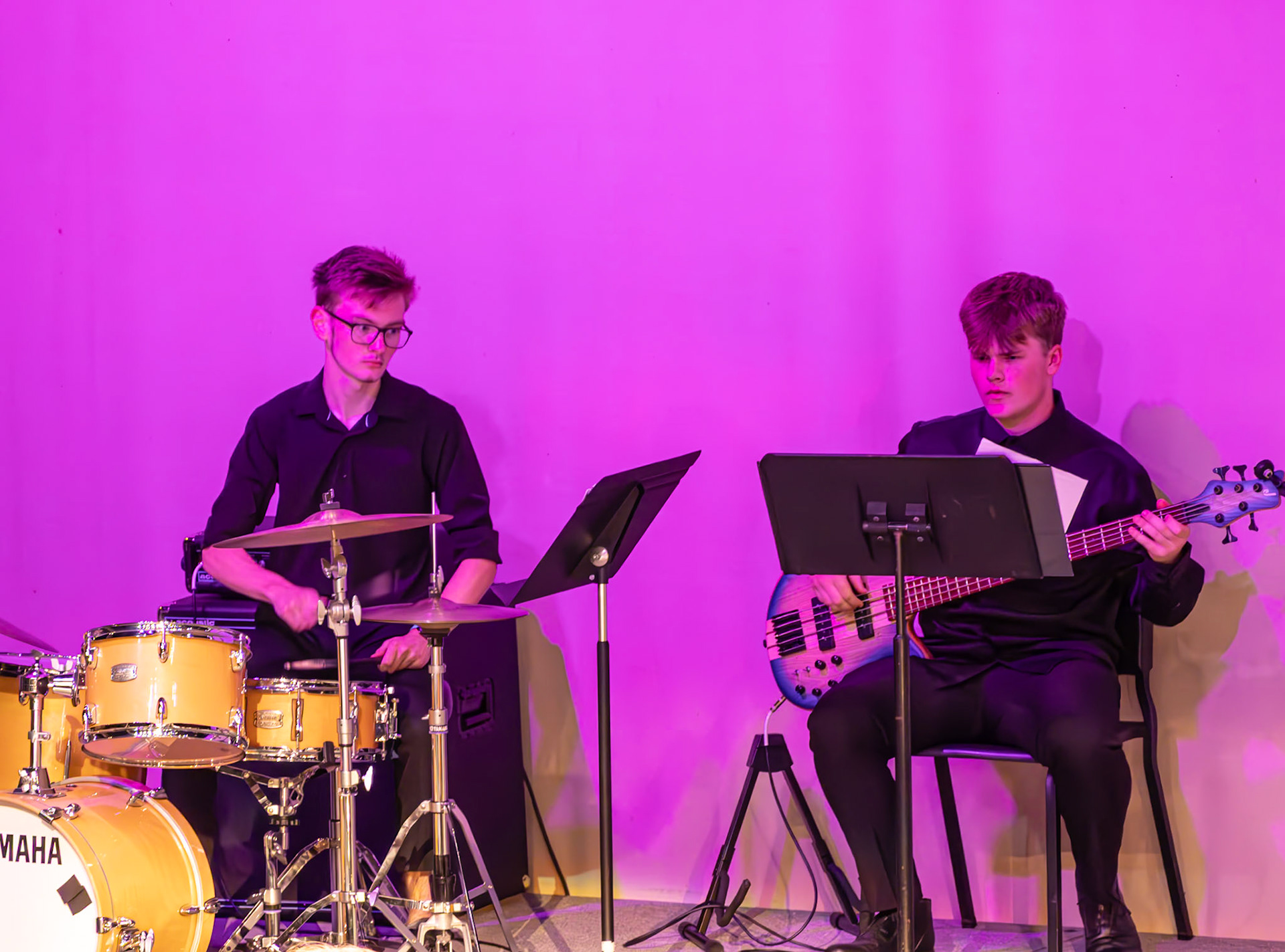 Miles Dood jams out on guitar for his concert debut as Benji Rewa provides the driving beat on drums. (Photo by Molly Larson)