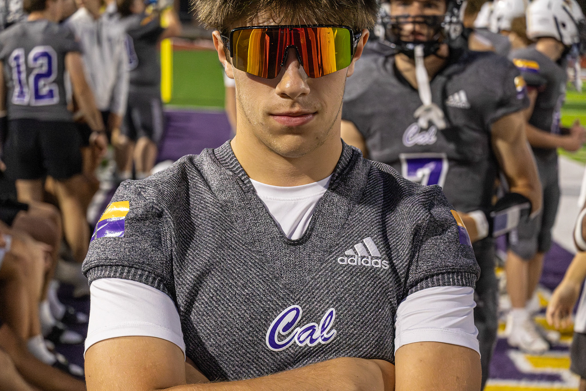 Even from the sidelines, injured Marco stays ready as the team’s secret weapon while supporting them against East Kentwood. (Photo by Jeremiah Pitman)