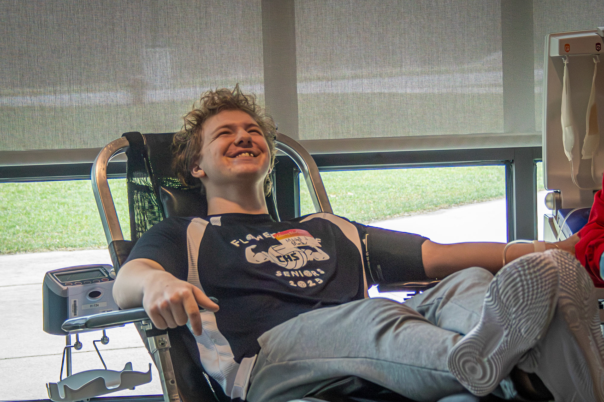 Even with a needle in his arm, senior Mitchell Moelker keeps smiling as he donates blood during the school blood drive.