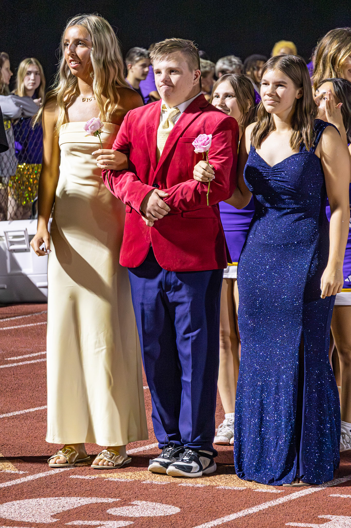 Brooklyn, Caleb, and Leah make their way down the track, celebrating Homecoming together (Photo by Taya Penoes)