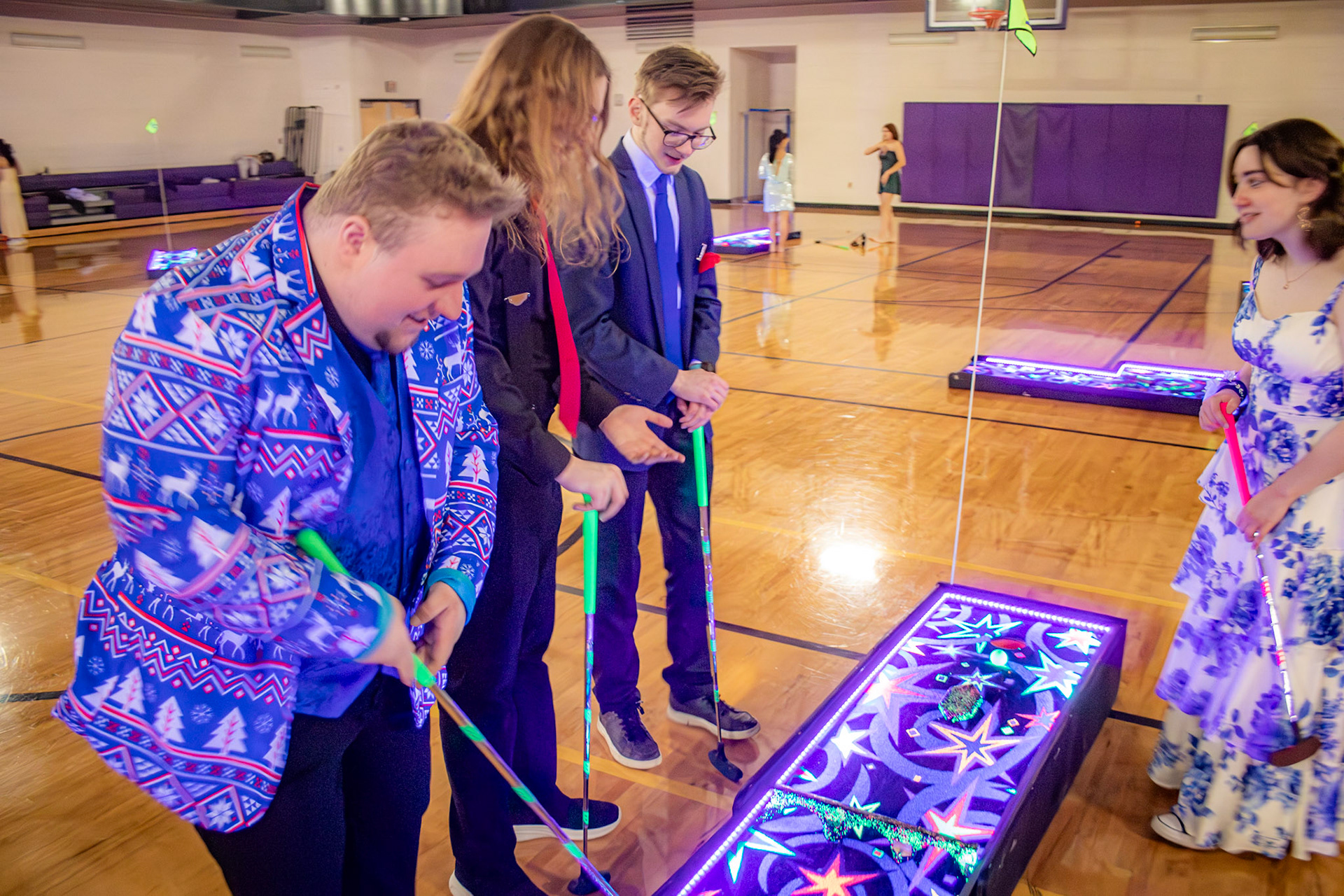 Alister Brew, with friends Owen Williams, Benji Rewa and Lydia Shoesmith enjoy a quick game of putt-putt during the 2026 Winterfest Dance.(Photo by Lucas Swartz)