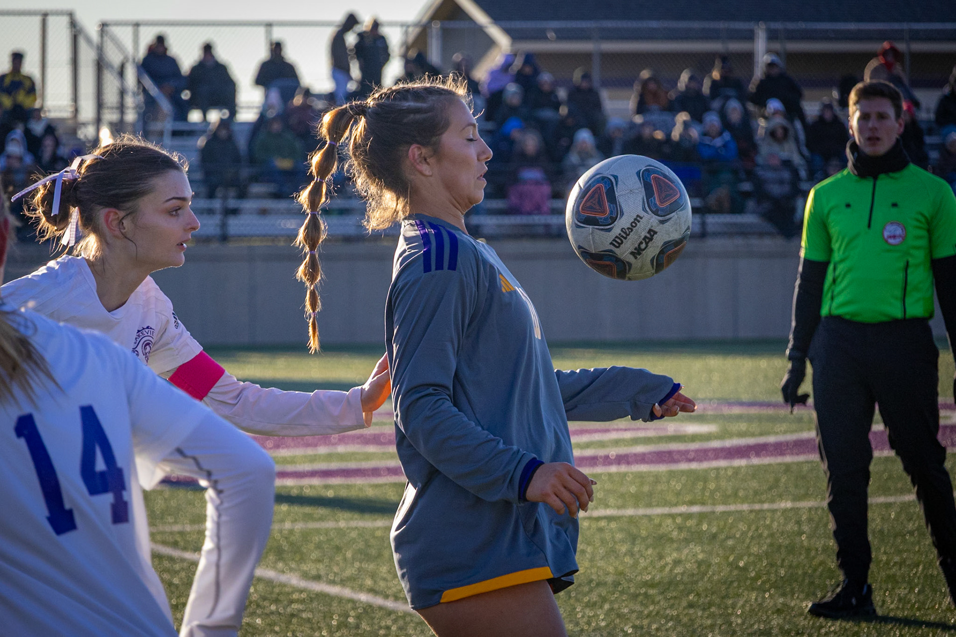 Senior Baylee DeVries keeps possession as defenders from the opposing team close in. (Photo by Rhyan Guzman)
