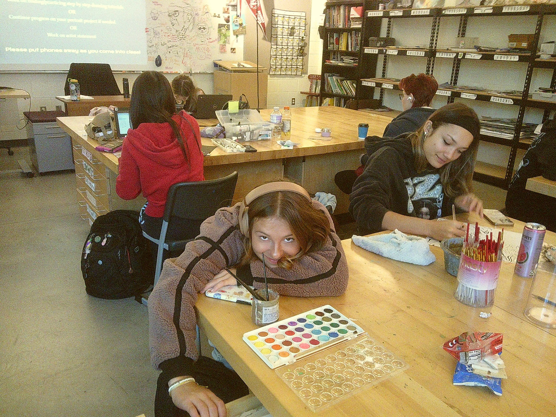 Senior Baylee DeVries is wiped out after completing her watercolor in Drawing and Painting class. (Photo by Tana Coates)