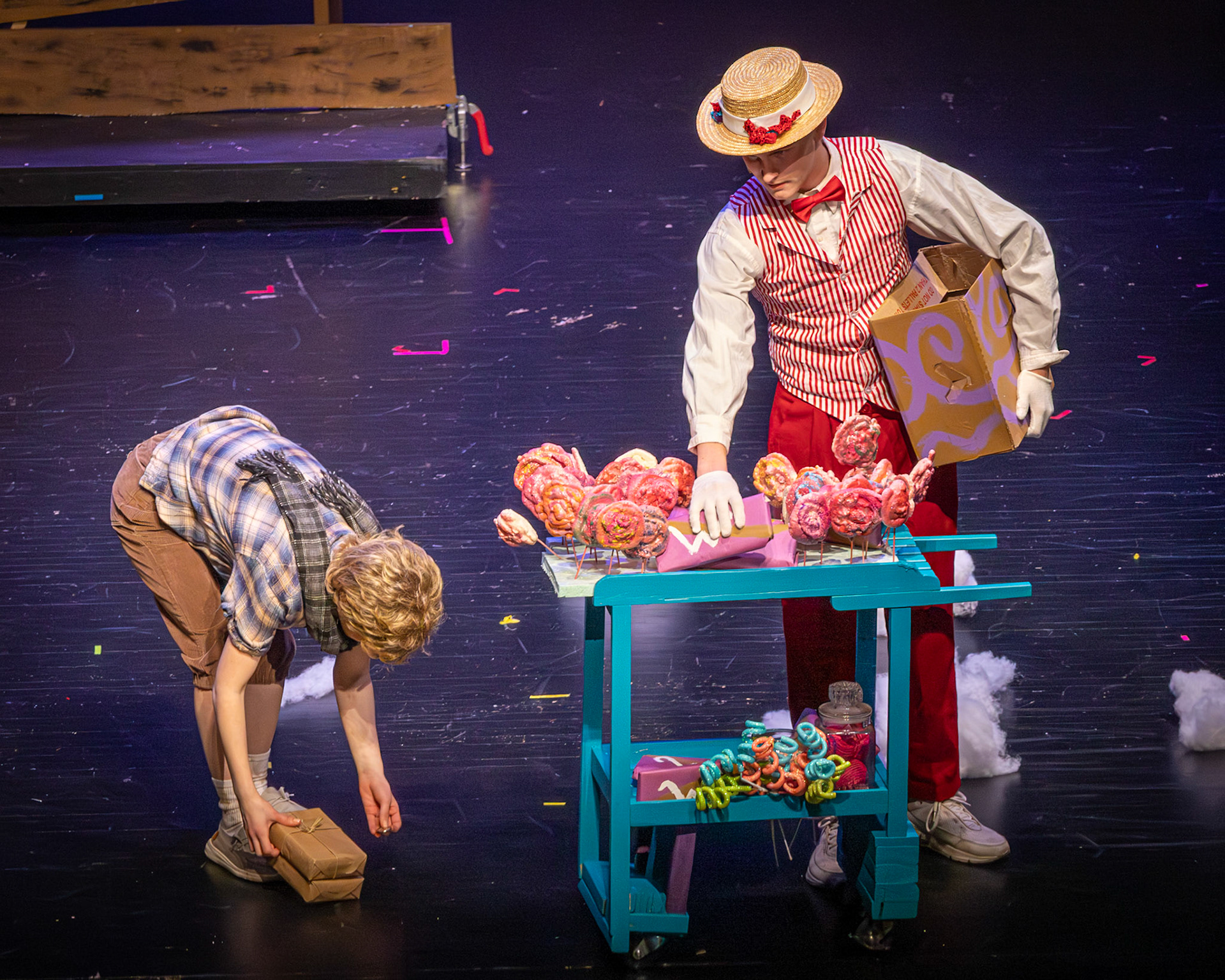 After Connor Parlin's Candy Seller drops his goods, Charlie (played by Emma Kellogg) helps gather them, discovering a coin that will change the direction of the story. (Photo by Mackenzie Popma)