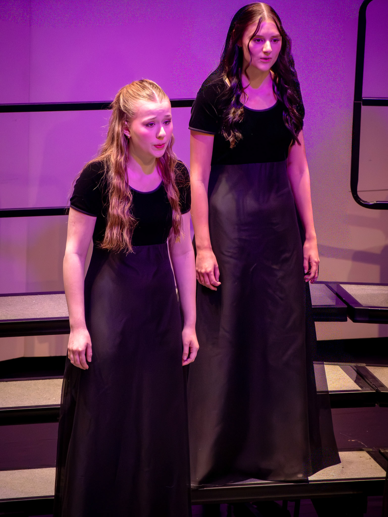 Evie Slump and Alexis Saidoo sing side by side, bringing powerful vocals and senior energy to the stage at the Treble Bass Concert. (Photo by Addi Thornton)
