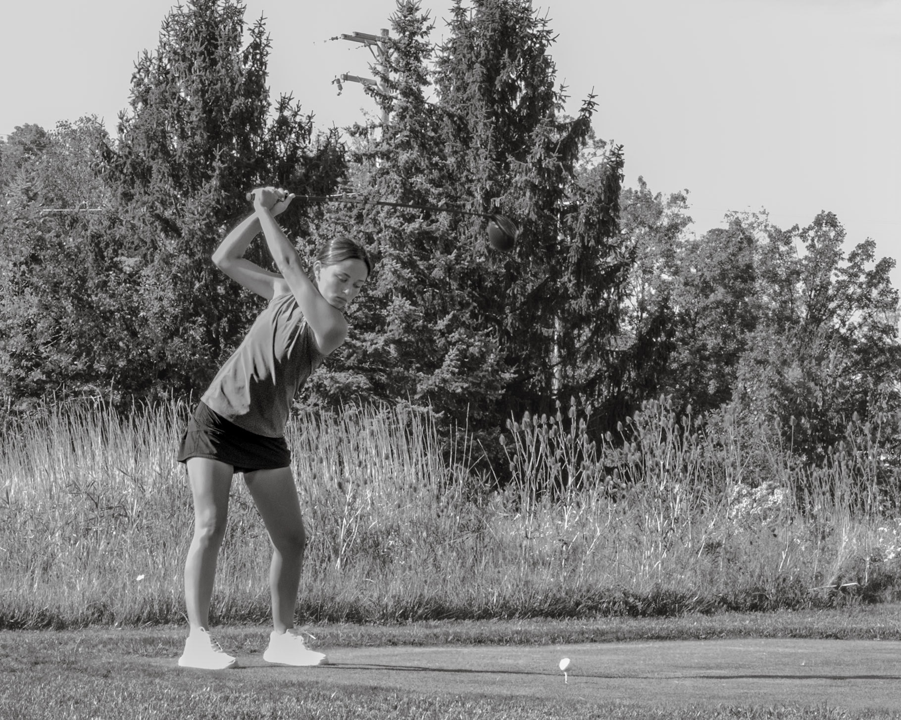 Senior Katie Honhart takes a big swing for a great shot off the tee. (Photo by Ryder Born)