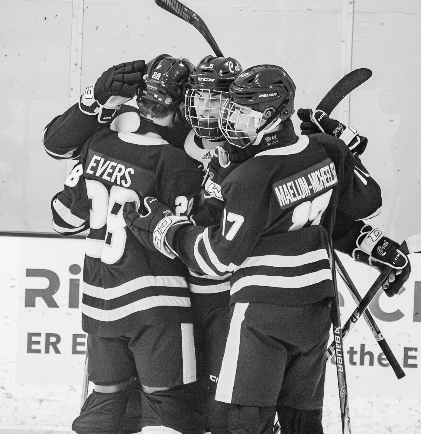 Thomas Evers, Ethan Sova, and Jagger Burnes celebrate after an hard-fought goal against the Grand Rapids Christian Eagles. (Photo by Ollie Fox)