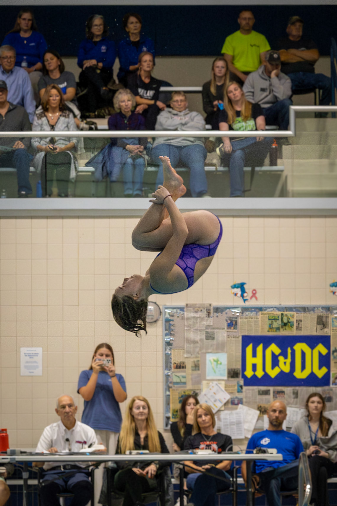 Lily Smith arches through the air, completing her front flip just before hitting the pool. (Photo by Hailey Thayer)