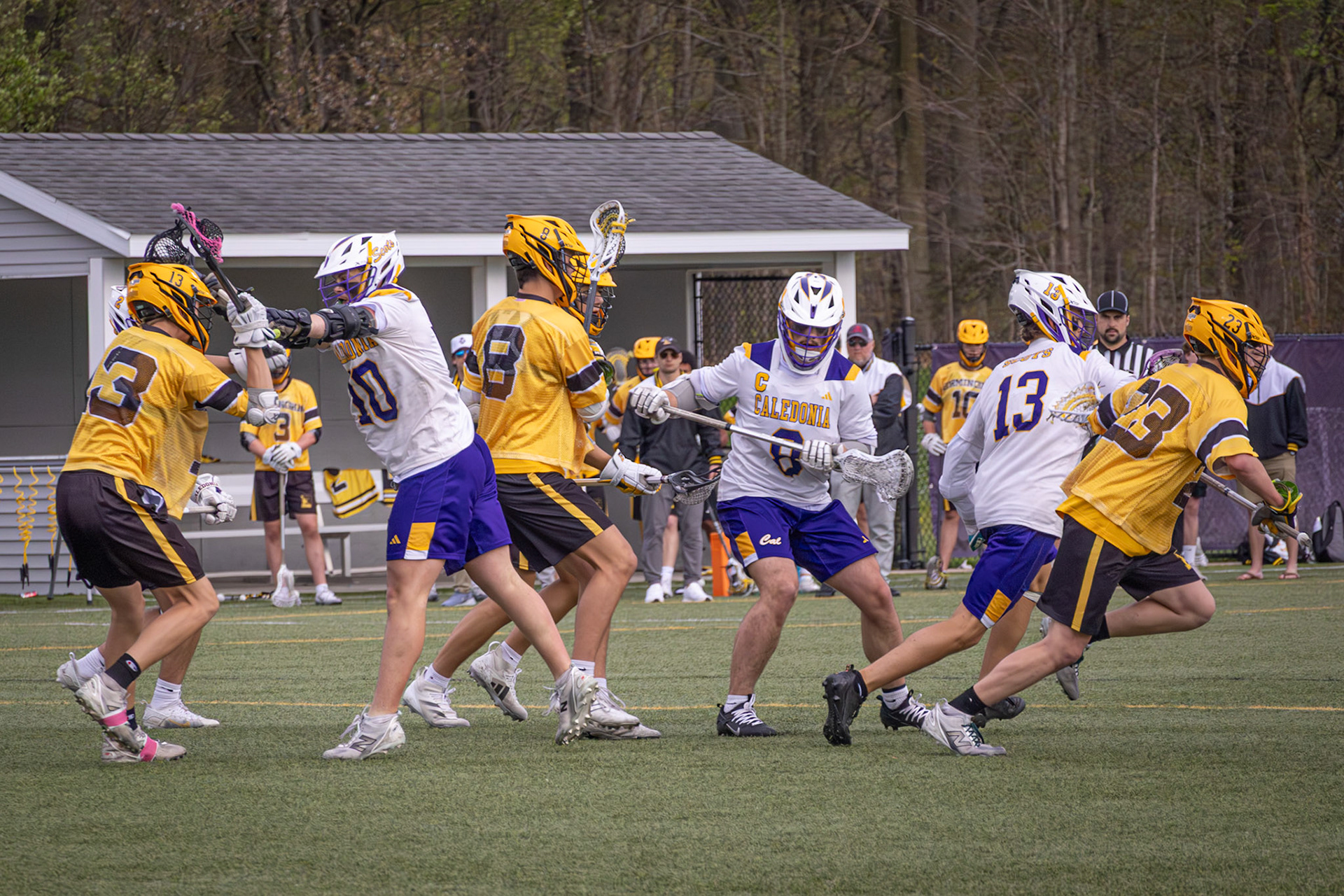 Rylan Bultema and Emmett Haan hold the line at midfield, applying pressure as Ryder Born looks to carry the ball forward (Photo by Abby Skibinski).