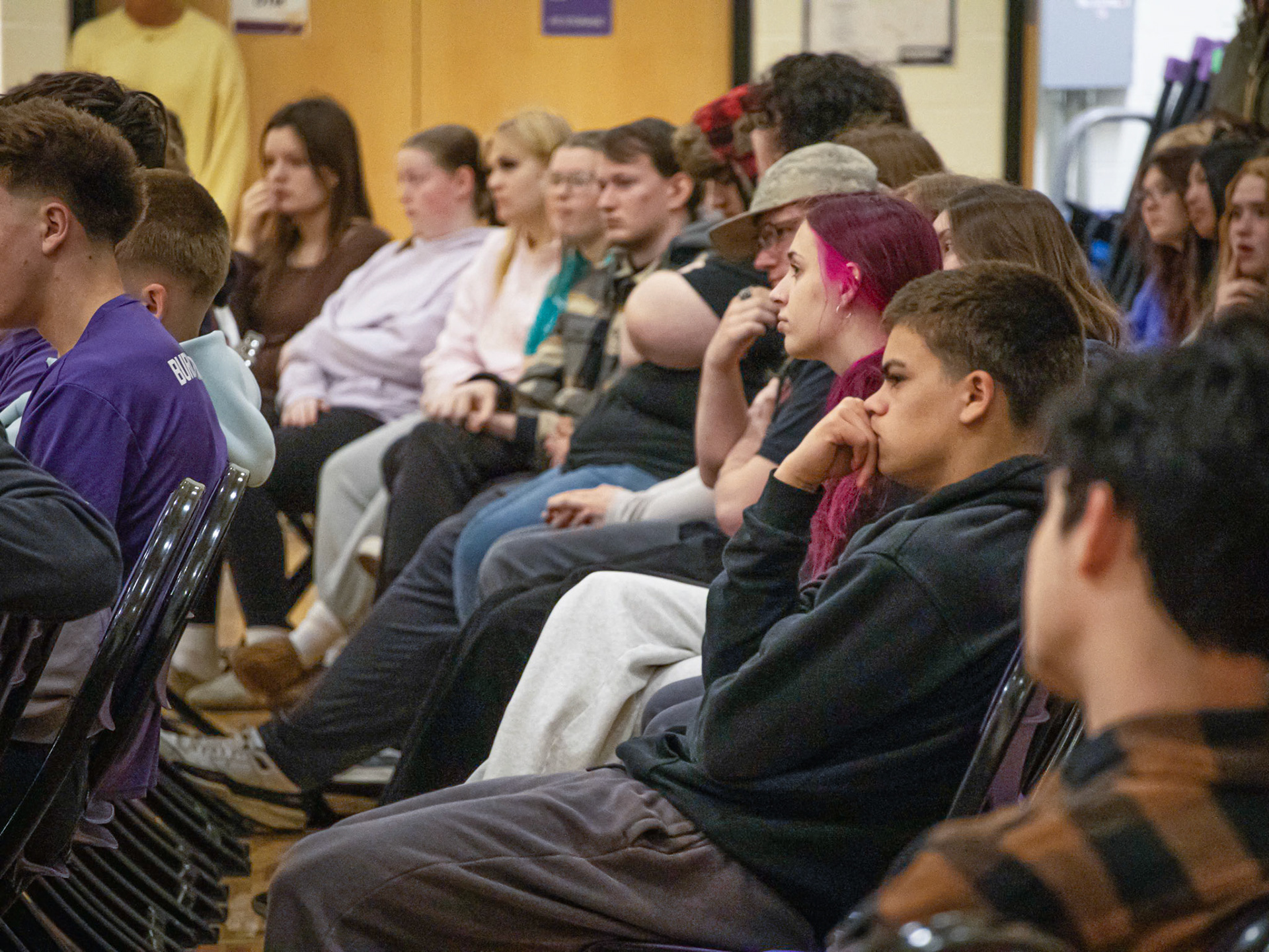 As a memorial video honoring Joelyn Abraham plays during the assembly, students like Trey Curnow sink into their chairs and fall silent as emotion fills the crowd. (Photo by Ella-Grace Wickens)