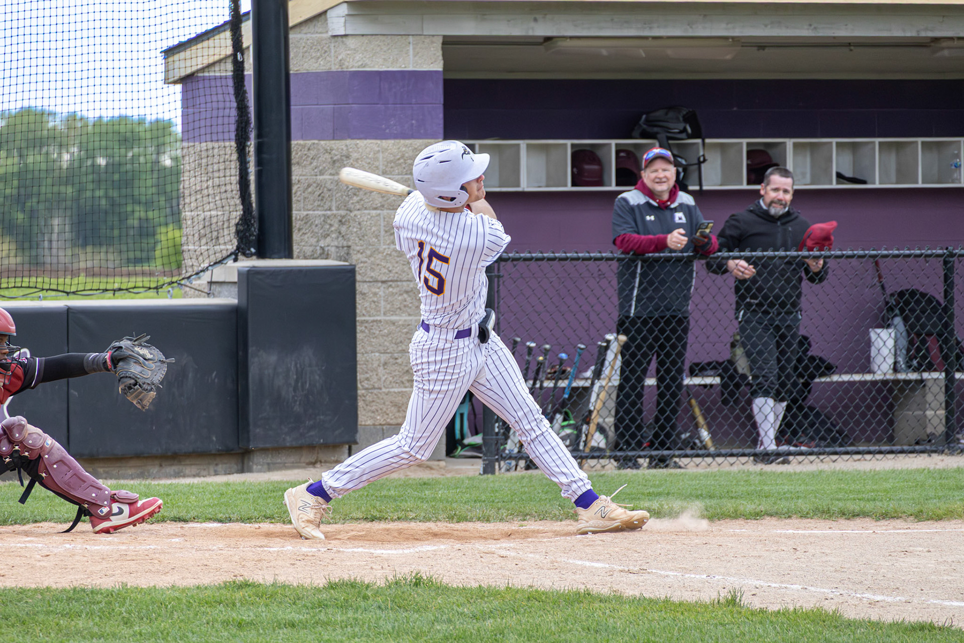 Junior Ethan Sova follows through on his swing during the Scots’ matchup against Muskegon. (Photo by Vivian Hoffman)