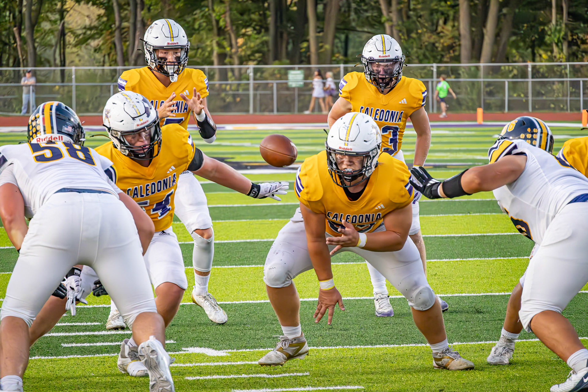 Thomas Hodgson throws the ball to Andrew Hanna, who hands it off to Ryne Wysocki for an incredible play. (Photo by Taya Penoes)