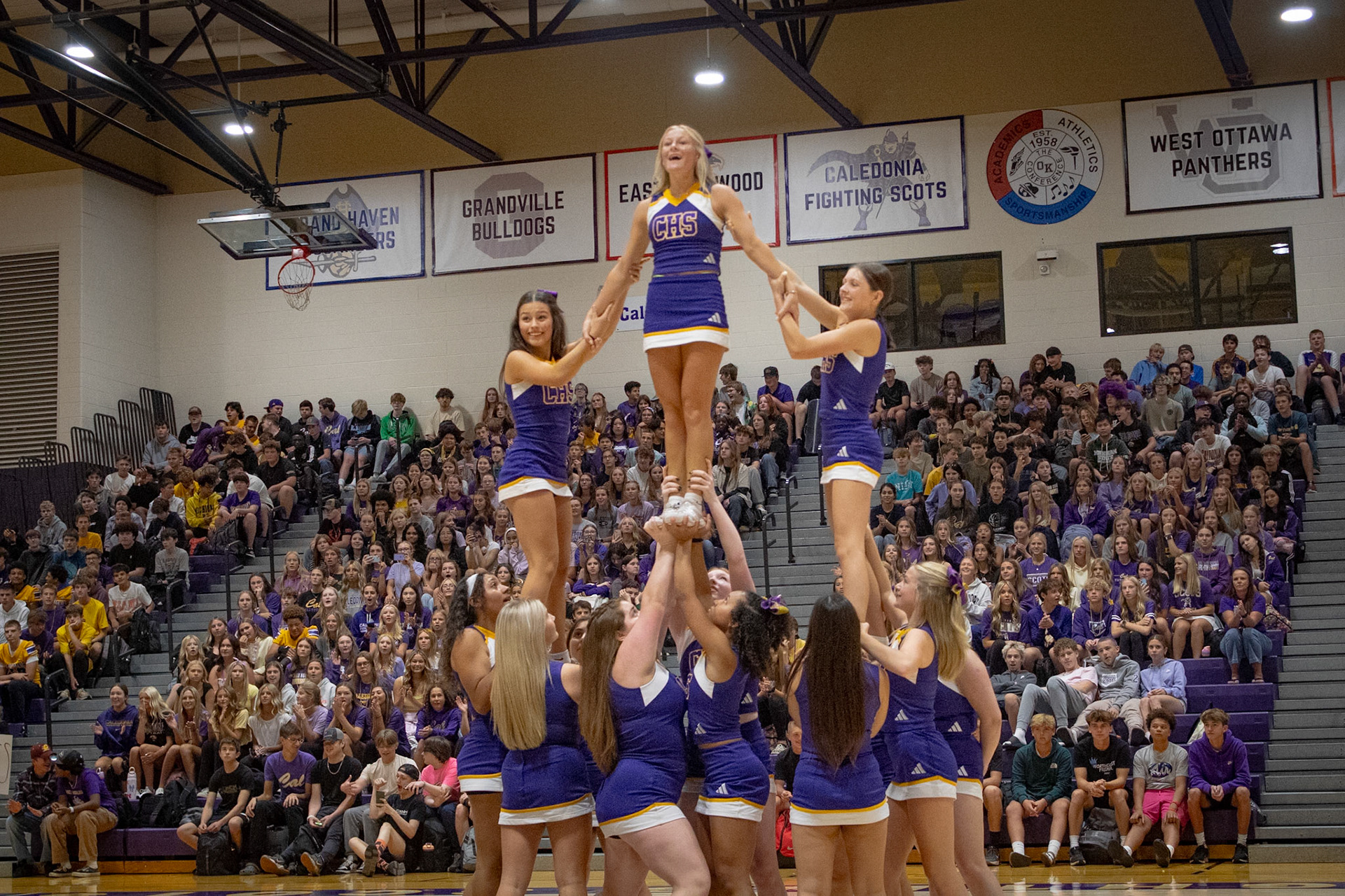 The cheerleaders form a perfect pyramid, showcasing strength and teamwork at the homecoming assembly. (Photo by Aslyn Crocker)