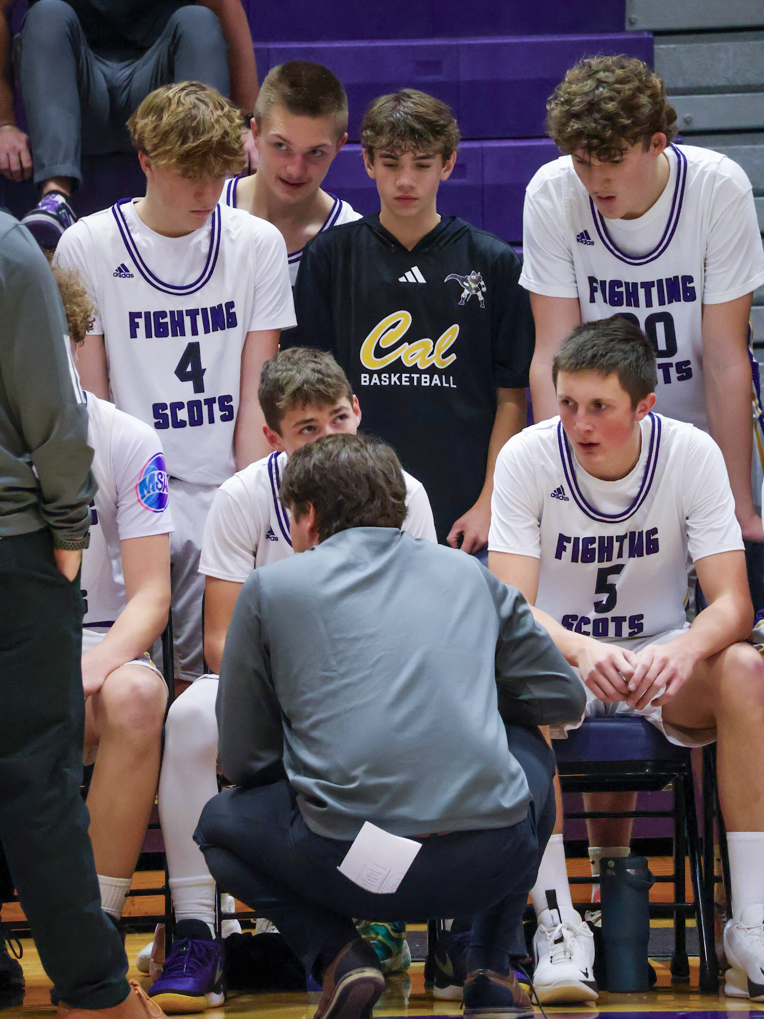 The team listens closely as the coach changes some plays. (Photo by Mackenzie Popma)