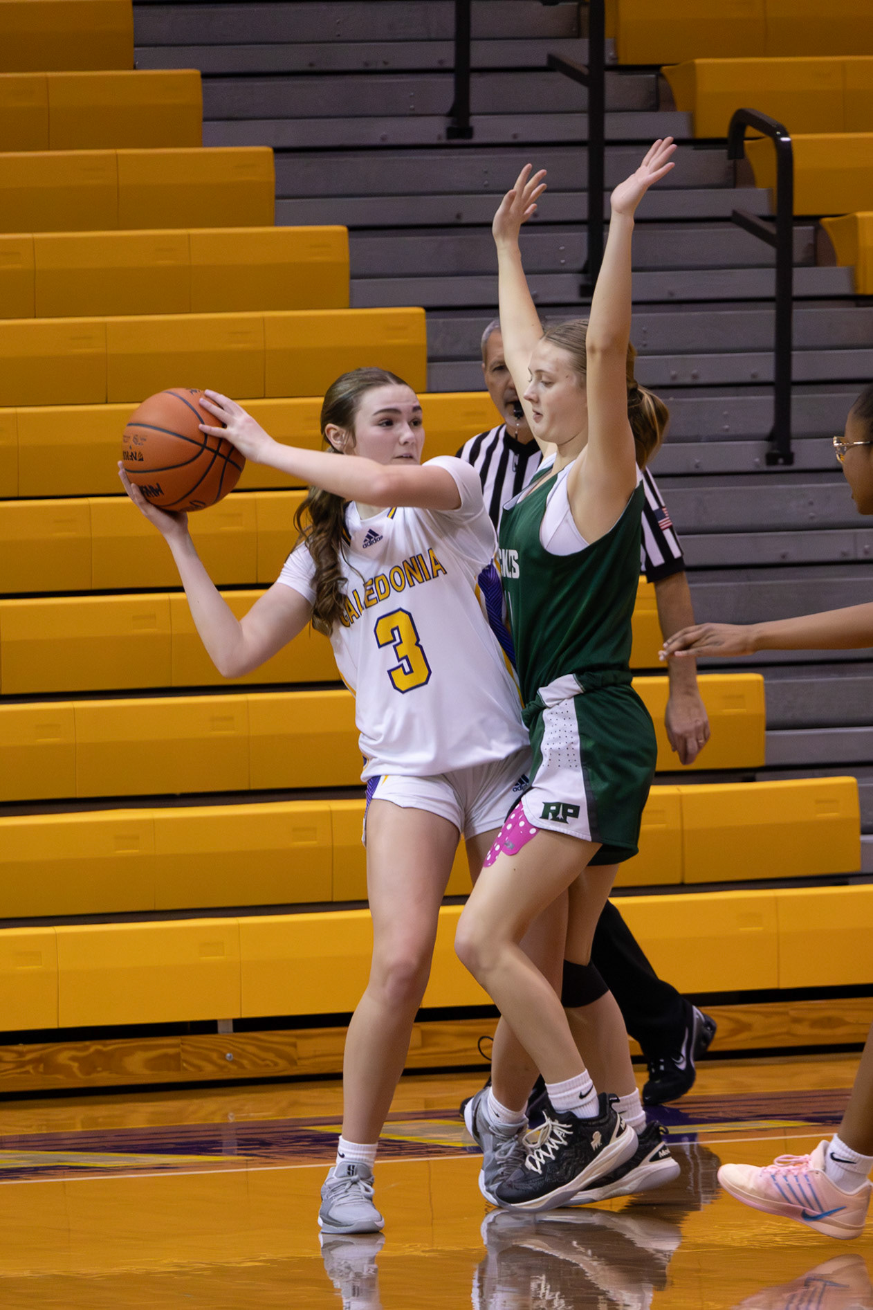 Sophomore Emery James fights through the pressure—blocked mid-pass but never backing down from the play. (Photo by Mackenzie Popma)