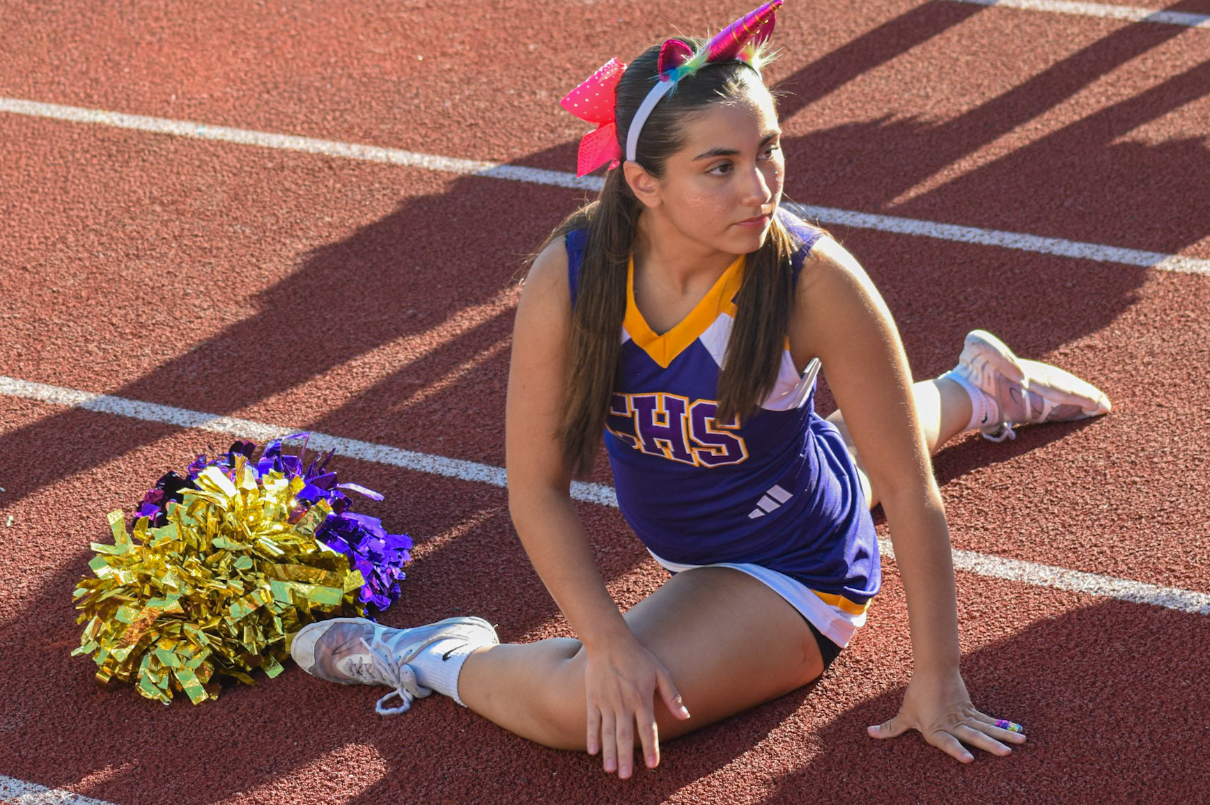 CHEER READY  Junior Grabriela Rissley stretches before performing some incredible stunts. (Photo by Ollie Fox)