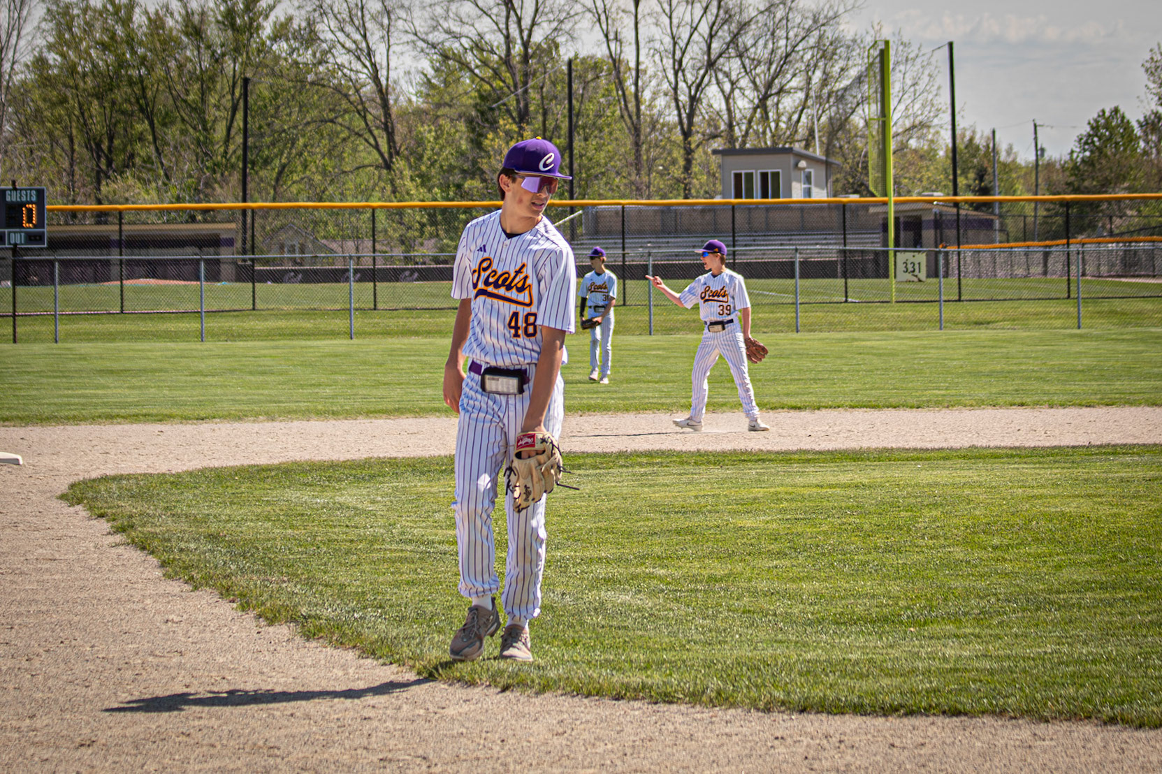 Cole Thompson waits at third base for the ball to get passed to hom so he can get his opponet out.(photo by ElshaBytwork)