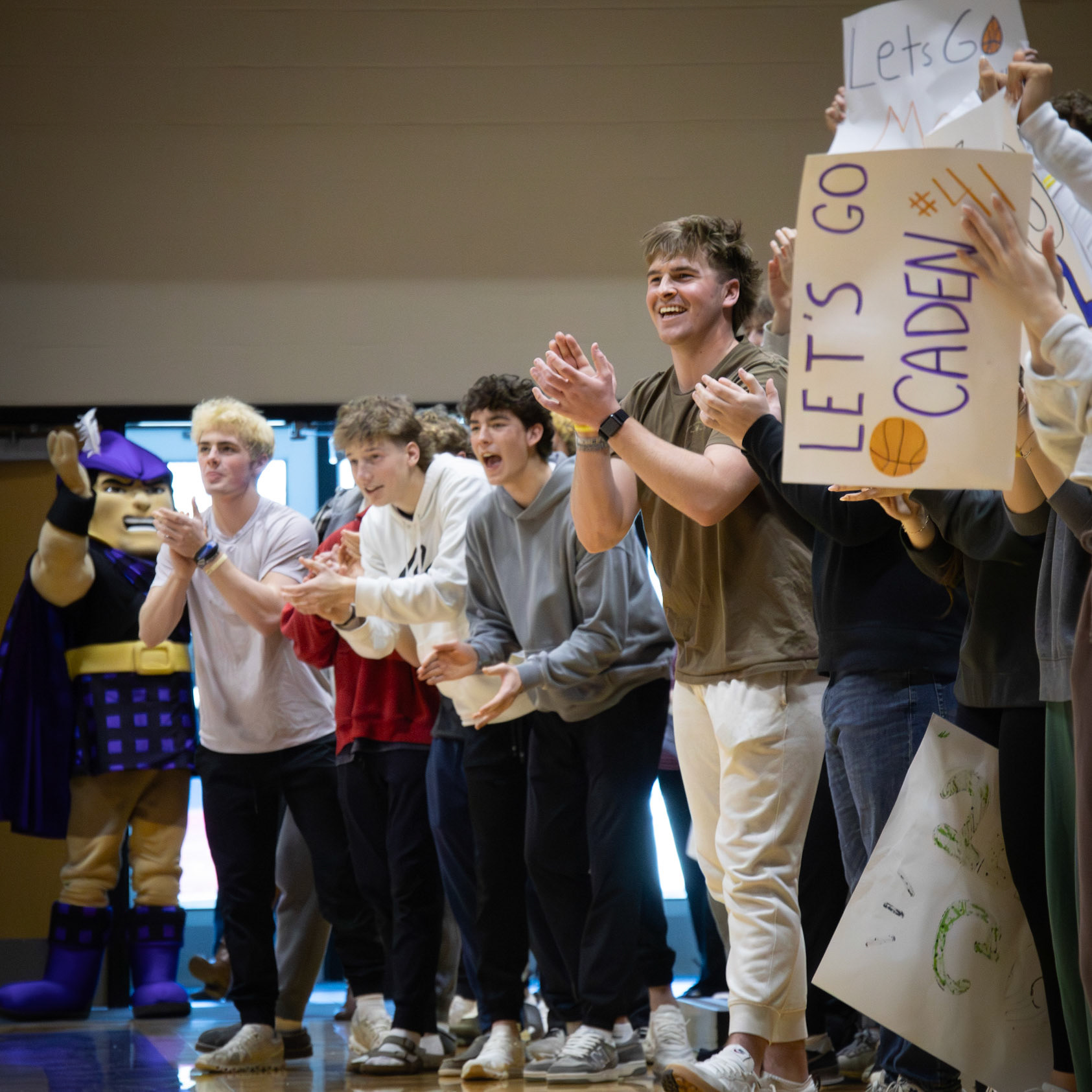 Celebrating from the sidelines, seniors Ty Lewandowski, Evan Standley, Gabe Trudeau, and Elliot Clark show their support after a Caledonia Unified player scores. (Photo by Abby Skibinski
