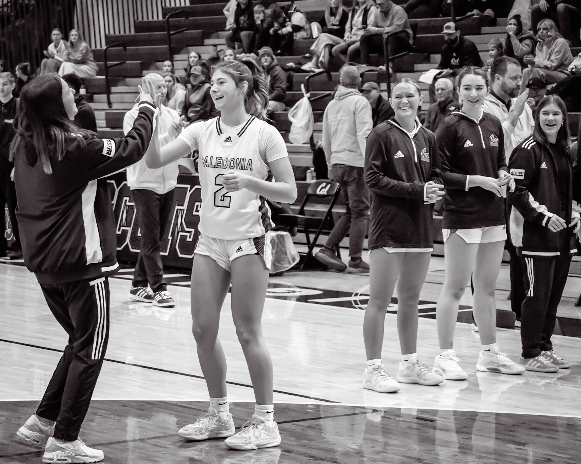Kayla Briseno and Emily Stauffer with their pre-game high-five tradition. (Photo by Tana Coates)
