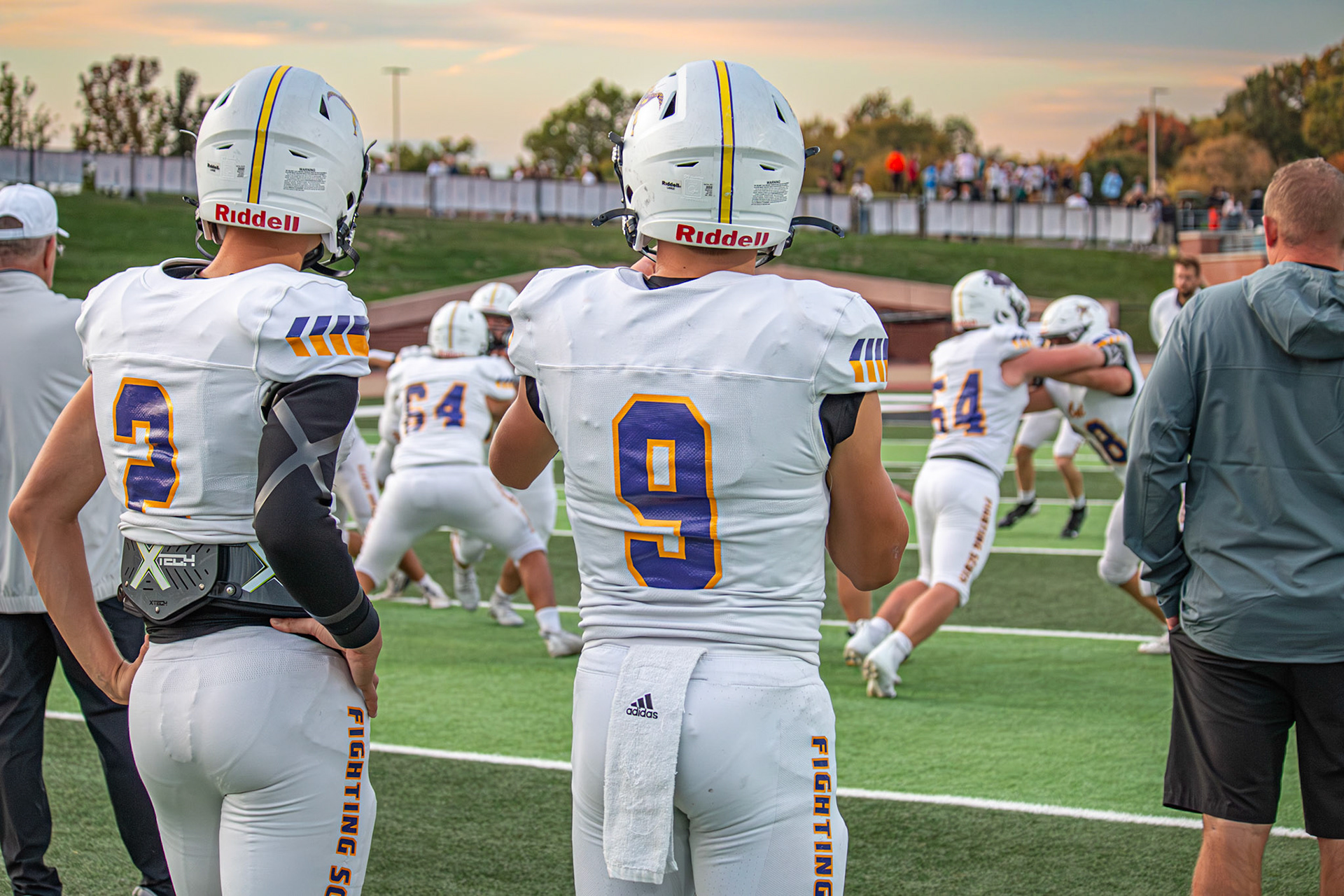 LEARNING THE PLAY Sophomore quarterback Conlan Schultz takes notes from starting junior quarterback Bryce Backus. (Photo by Egan Otto)