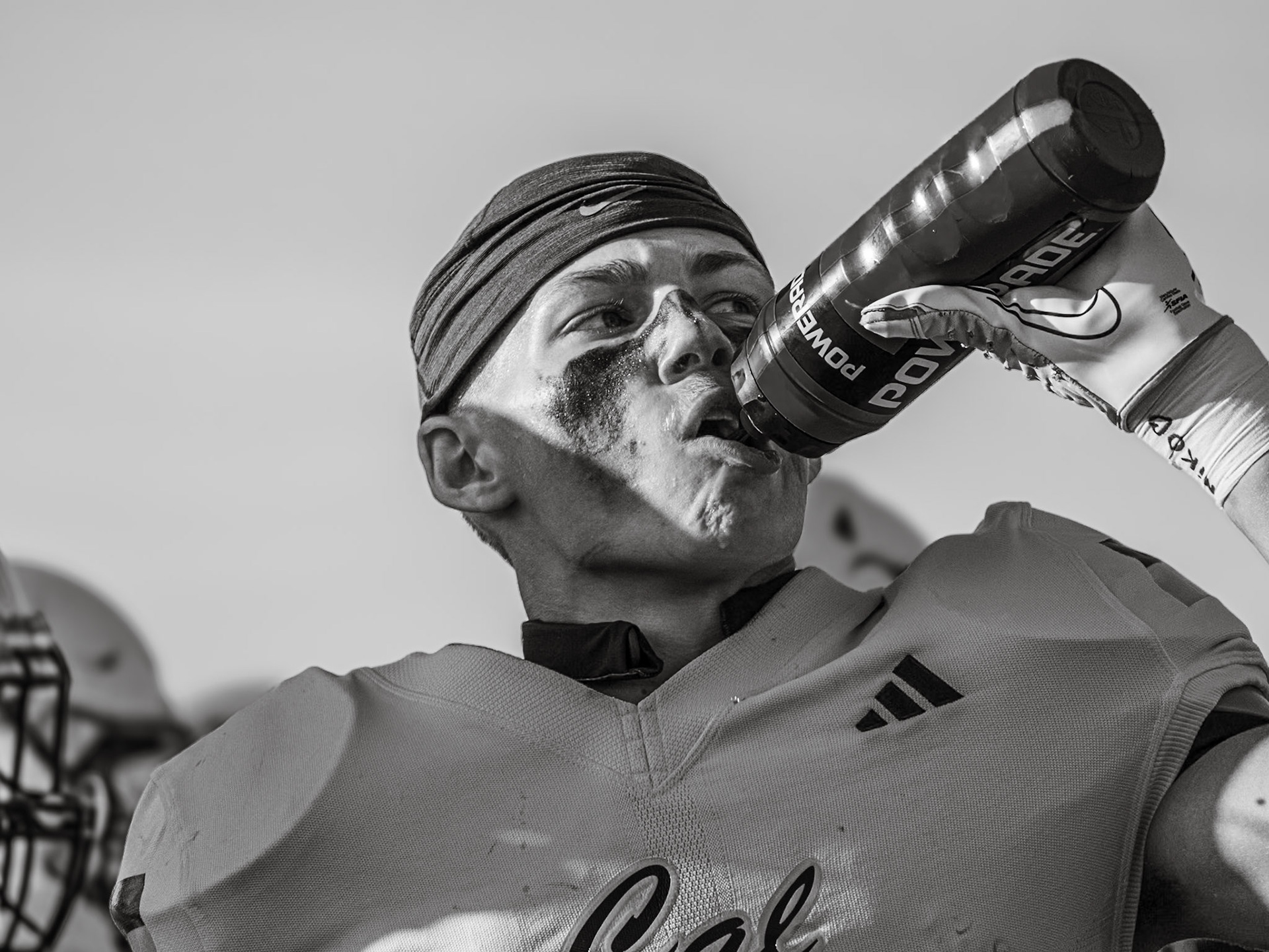 IN THE ZONE Mid-game against Hudsonville, Ben Geerdes cools off with a quick water break on a hot afternon (Photo by Lillian Jackson)