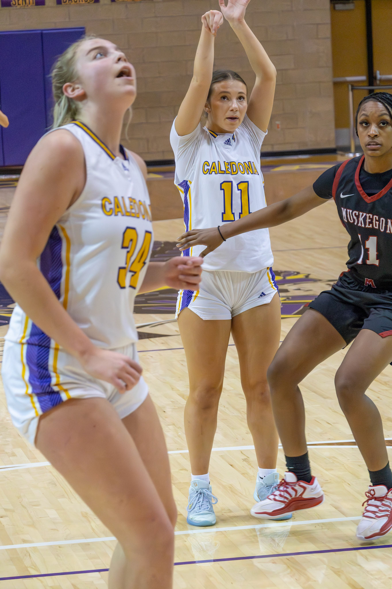 NOTHING BUT NET Baylee DeVries converts a free throw as Mallory Graham reacts during varsity play against Muskegon. (Photo by Taya Penoes)