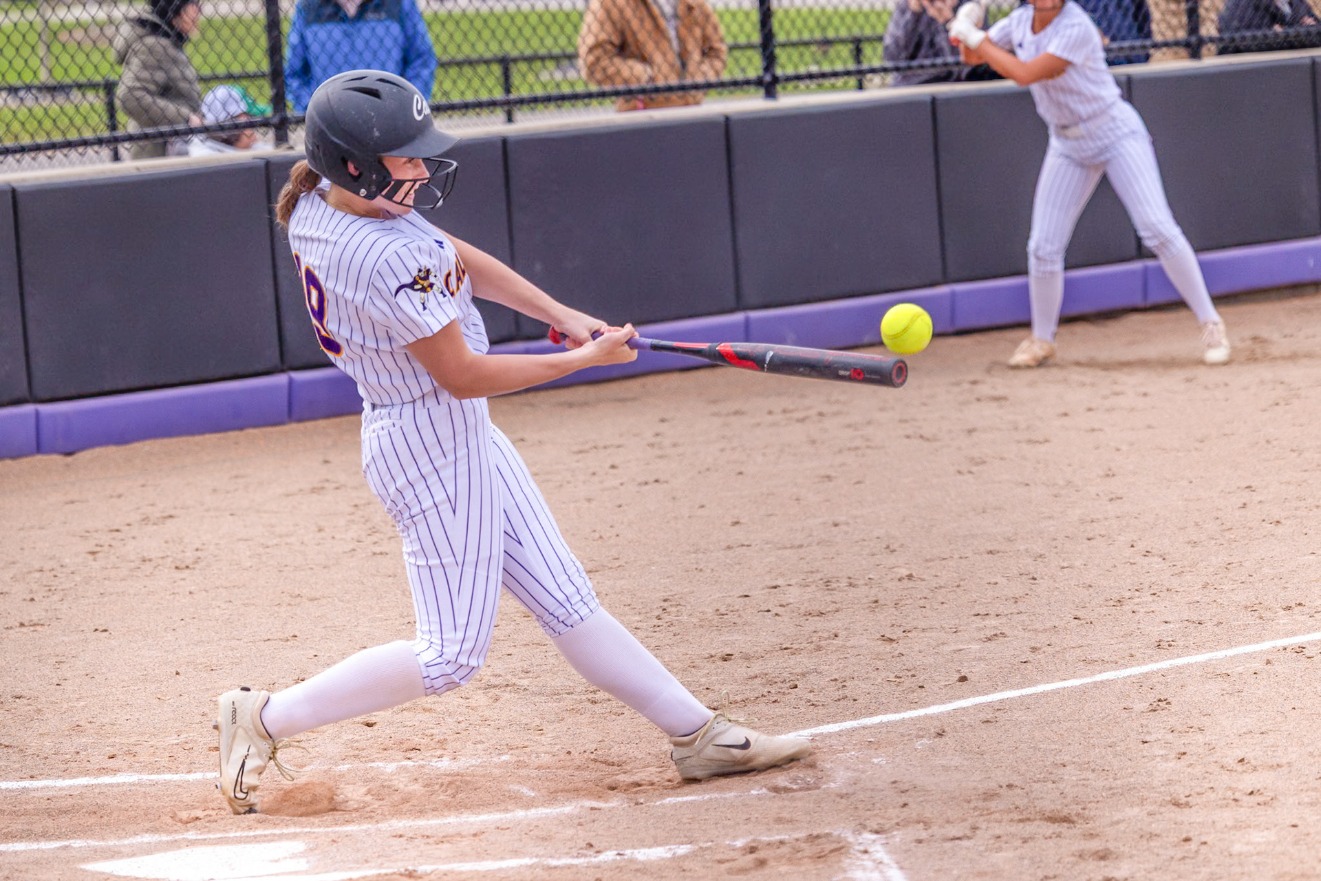 Kaitelyn Light barrels up a pitch and sends it into play for the Scots offense. (Photo by Landry Mueller)