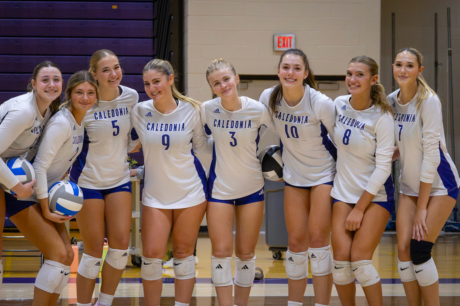 Varsity volleyball girls all smiles before their teacher appreciation night game. (Photo by Khloe Lowande)