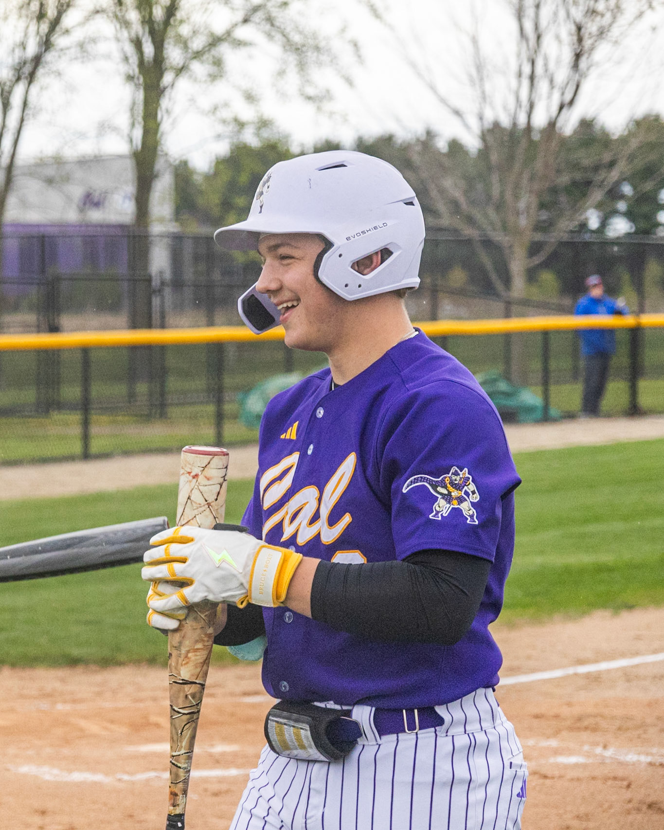 Justin Golembeske smiles with his teamates between innings during the game. (Photo by Emma Garza)