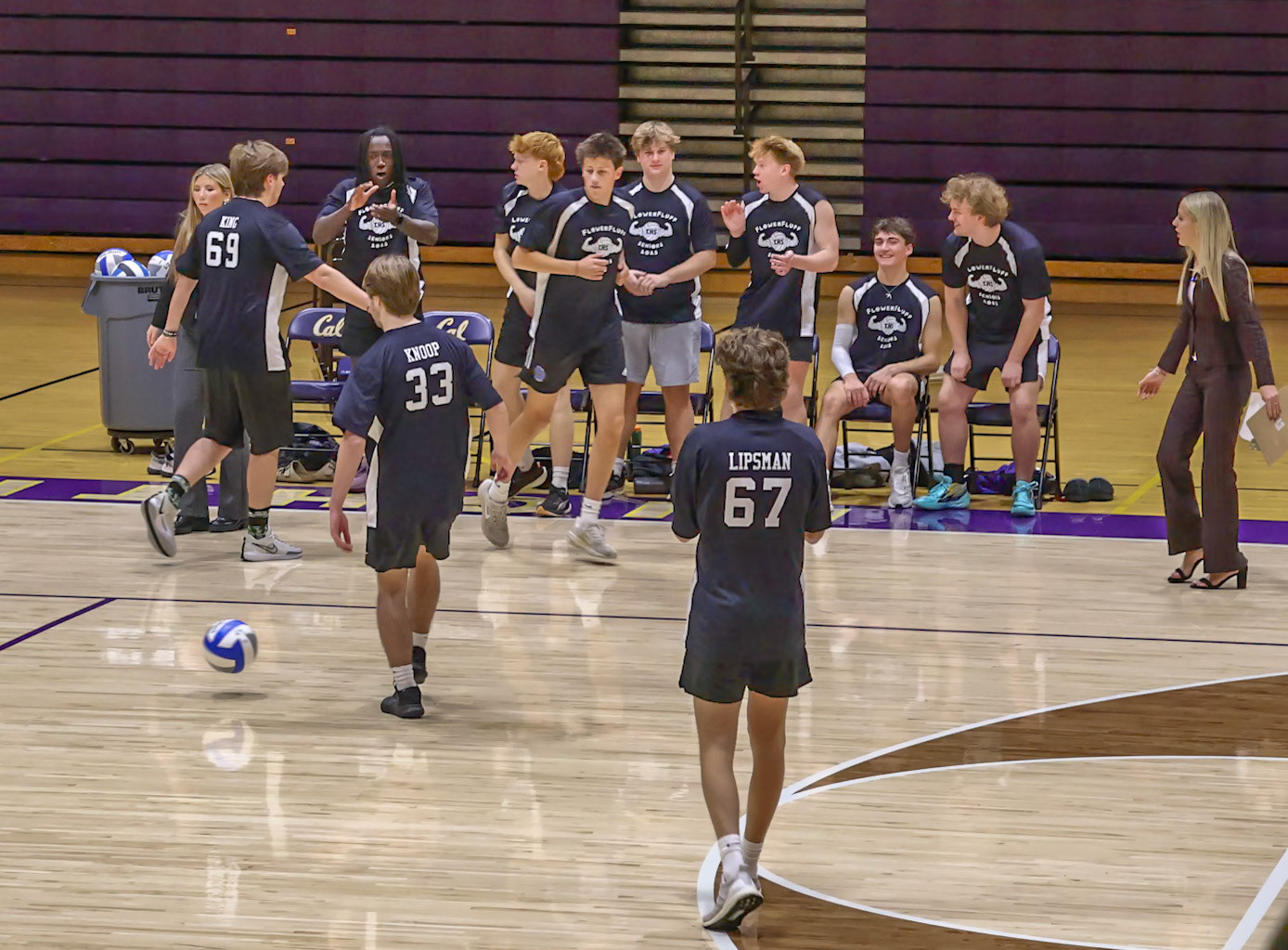 The senior team celebrates their point gained through high fives and hand claps. (Photo by Abigail Tava)