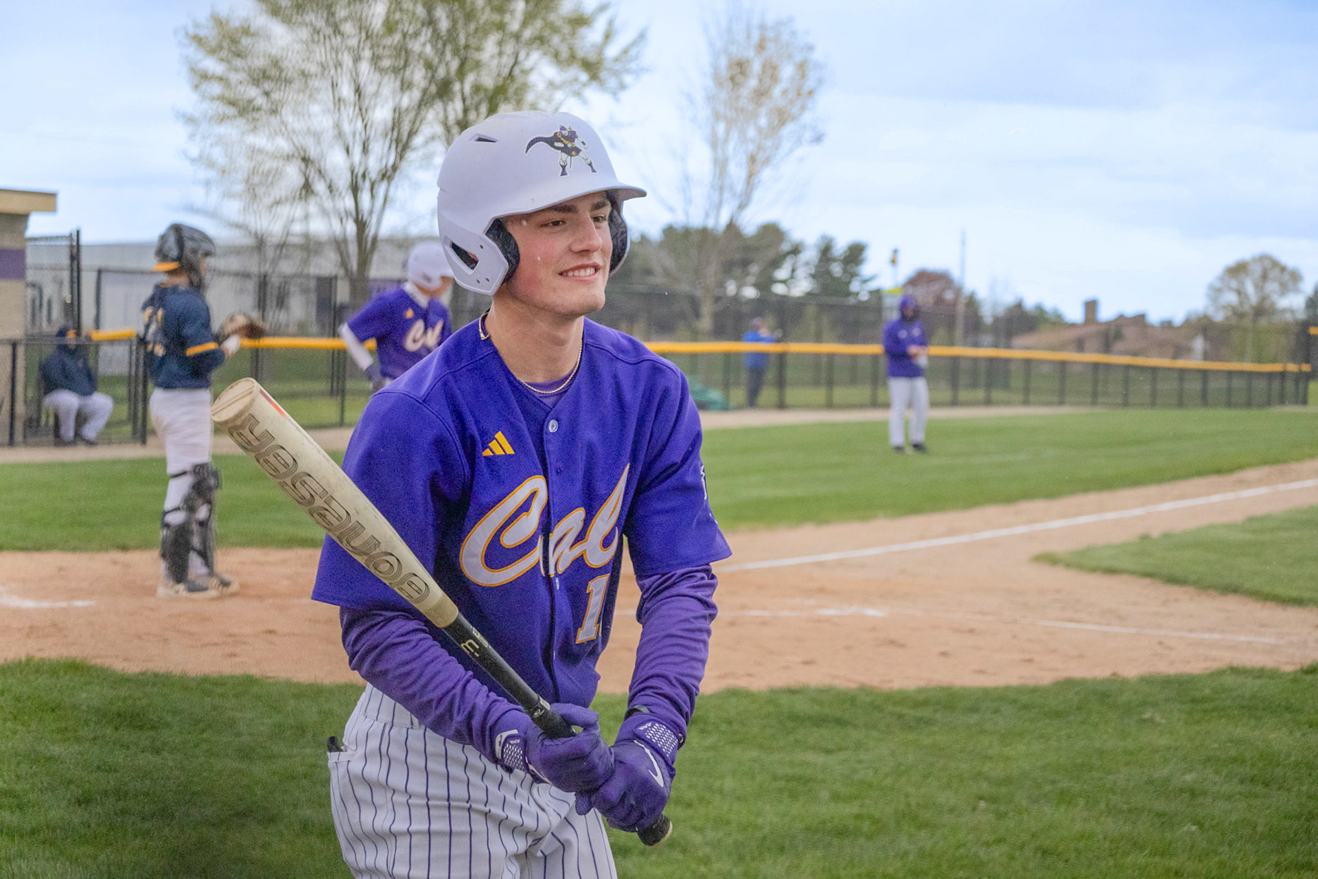 Ty Lewandowski warms up on deck before going up to bat. (Photo by Ella-Grace Wickens)