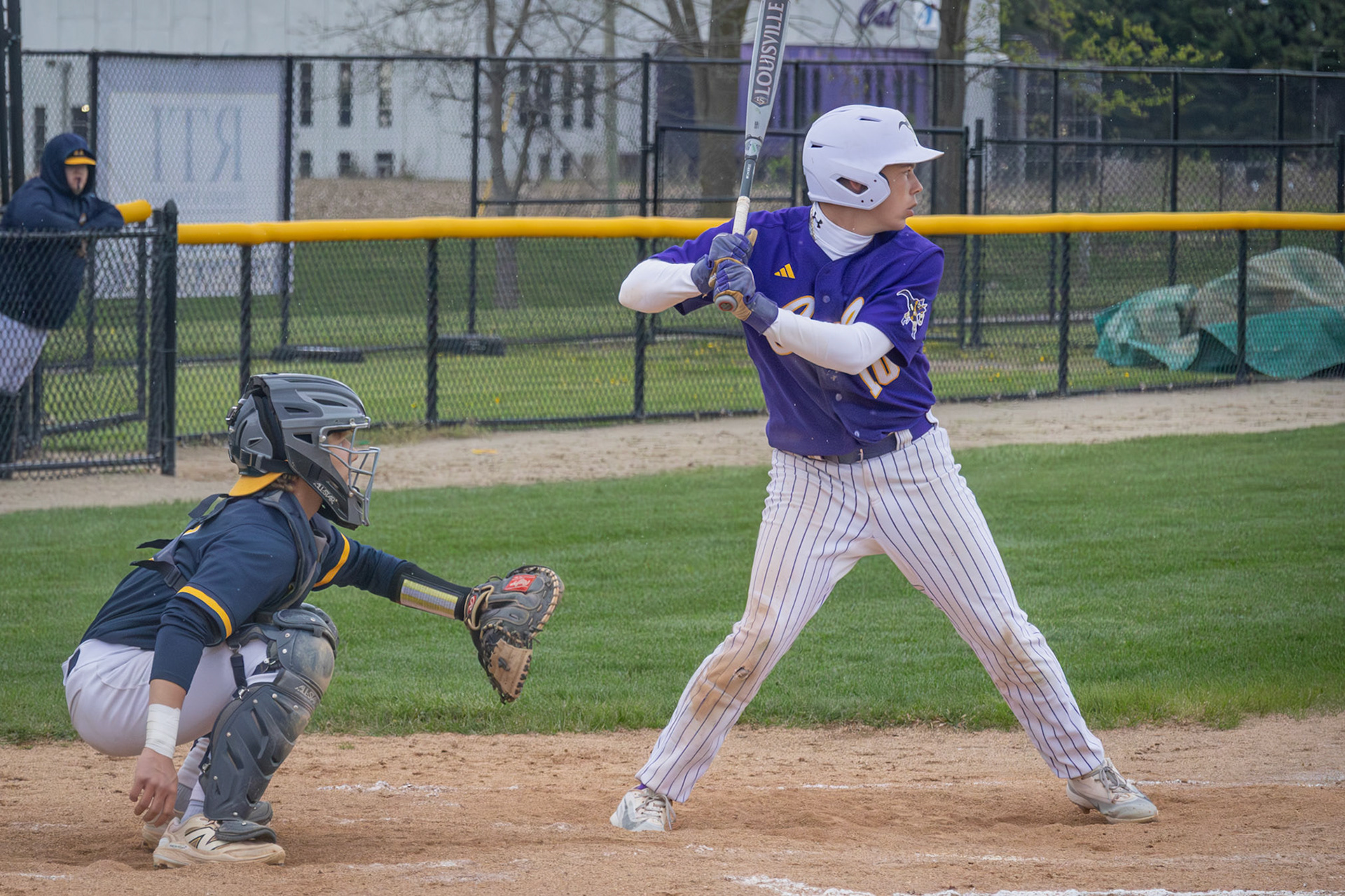 Jackson McNew focuses on the incoming pitch during a tense moment at bat. (Photo by Emma Garza)