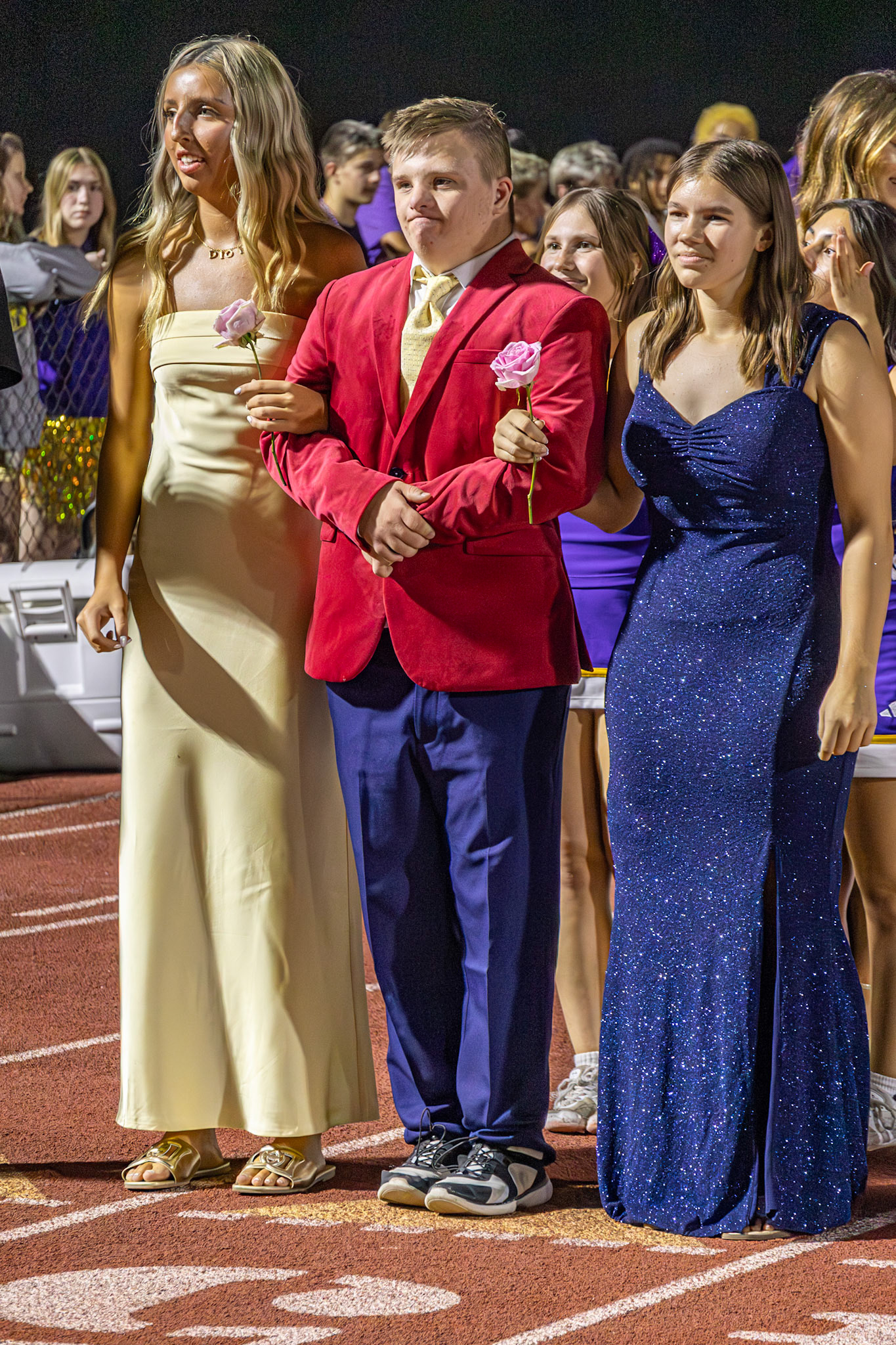Brooklyn, Caleb, and Leah make their way down the track, celebrating Homecoming together (Photo by Taya Penoes)