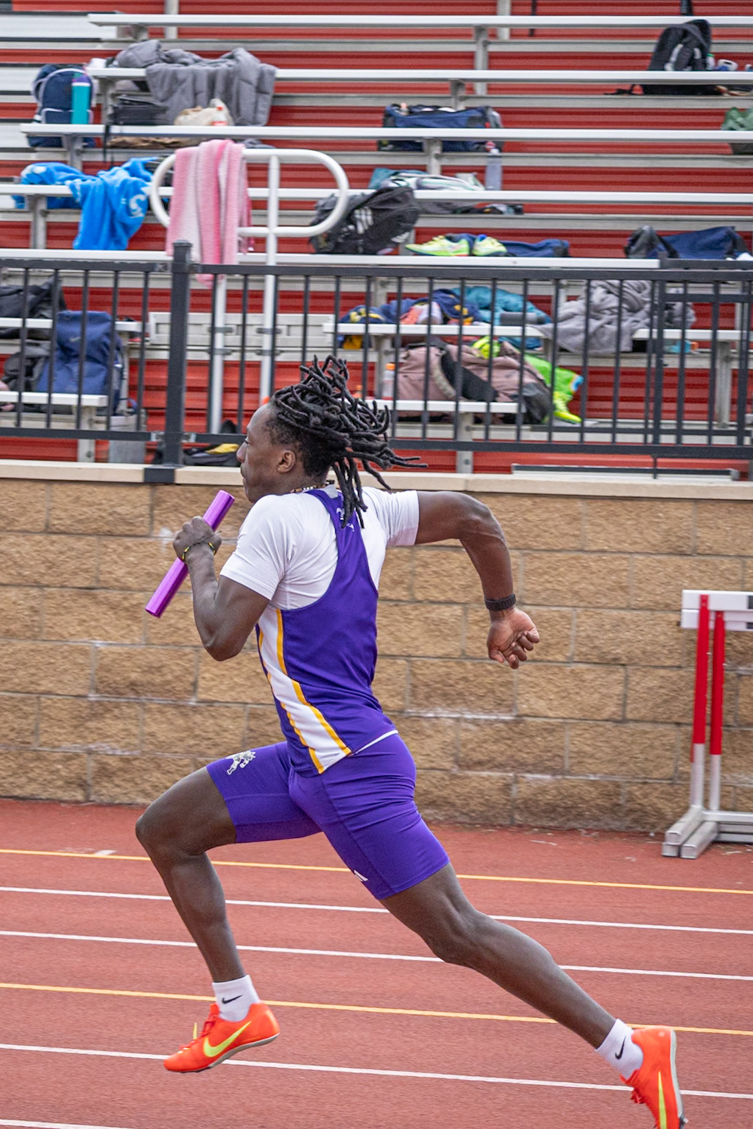 Blink and you’ll miss him — Levi Dorband explodes down the 4x100 and powers the team to a blazing finish. (Photo by Mya VanderZwaag)