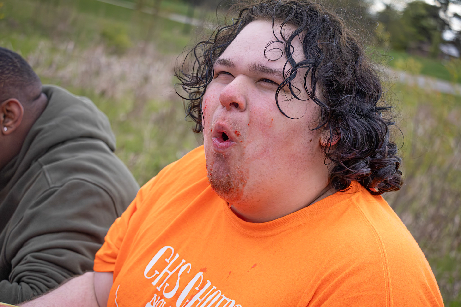 Junior Austin Robinson makes a sour face while competing in the sour watermelon eating contest, determined to come out on top. “I was so locked in trying to win this contest. I feel like it would be fun watching others do an apple bobbing contest if we did different foods one year.” (Photo by Judah Dorband)